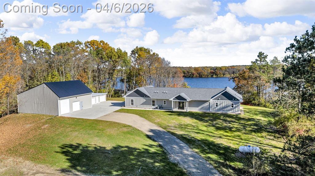 Incredible design, breathtaking views, unmatched privacy, and elevated finishes define this extraordinary lakefront retreat on all-sports Crispell Lake. This newly constructed sprawling ranch offers true main-level living with multiple inviting spaces for relaxing and entertaining, 3 bedrooms and 3 bathrooms. The gourmet kitchen shines with expansive prep areas, walk-in pantry, chef's gas range, oversized built-in refrigerator and freezer, kettle faucet, and stunning stone countertops with seating for 6+. Heated floors add comfort throughout. The primary suite is a private sanctuary with a remarkable walk-in closet, spa-like bath, and direct access to the patio. Outdoors, enjoy terraced decking to the water's edge, multiple lounging areas, sweeping lake views, and unforgettable sunsets with 100 ft of frontage. A 2-car garage and large pole barn for all of your lake toys complete this exceptional property.