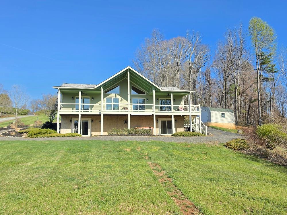 Nestled on 5 beautiful acres, this stunning mountain home offers a nice blend of comfort, charm, and outdoor beauty. Featuring 3 bedrooms and 3.5 baths, this property welcomes you with impressive timber frame covered front and back porches where you can relax and take in the breathtaking mountain views and peaceful pond views from the front porch. Inside, the home showcases cathedral ceilings and a warm, spacious layout with 2 bedrooms and 2.5 baths on the main level, making everyday living convenient and inviting. The partly finished full basement adds even more living space with an additional bedroom, full bath, and garage. Step outside to enjoy your own private retreat with a 16x32 heated pool installed in May 2025, a hot tub, extensive landscaping, and an outbuilding for storage or hobbies. With Hardi-Plank siding, a heat pump, tankless hot water heater, and a whole house generator, this home is beautifully equipped for comfort and peace of mind. Located just a short distance from Crooked Creek Wildlife Management Area and stocked trout streams, this exceptional property is ideal for anyone seeking scenic mountain living with easy access to outdoor recreation. Call Today!