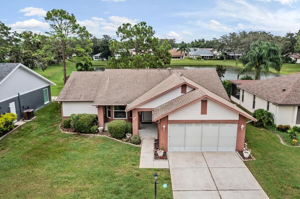 Here is one you've been waiting for! 2BR, 2BA, 2 Car garage home in neighborly 55+ Heritage Lake Community with pond views!  Home provides 1776 sq/ft of living space, is well maintained and move in ready.  New roof included in price to be installed prior to closing.  A/C with new ducts are 2 years old. Entire inside is freshly painted. Home has been upgraded with double pane, insulated windows and it waiting your own personal touches. Upon entry, notice the spacious living room/dining room combination with wood flooring giving separation from the informal areas of the home. Kitchen displays tile floors and offers plenty of cabinetry with newer, stainless steel appliances.  Family room is also roomy and provides views of the rear property and pond. Oversized lanai is enclosed with double pane windows and space a/c unit for all around the year use.  Outdoor patio is perfect for grilling, sunbathing and enjoying Florida outdoors. Laundry room contains wall hung sink and upper cabinets. Garage door has been upgraded with latest wind codes. Heritage lake features an active, 55 and over lifestyle with clubhouse, pool, spa, tennis, pickleball and shuffleboard. Many activities are planned bring residents together.  Close to shopping, hospital/healthcare and restaurants. This one won't last long.