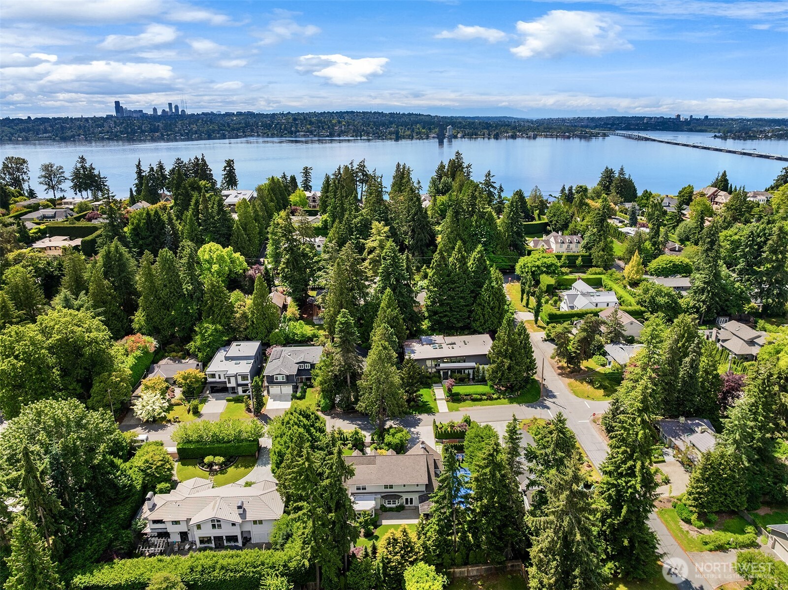 Aerial view frames the home against Lake Washington and the Seattle skyline