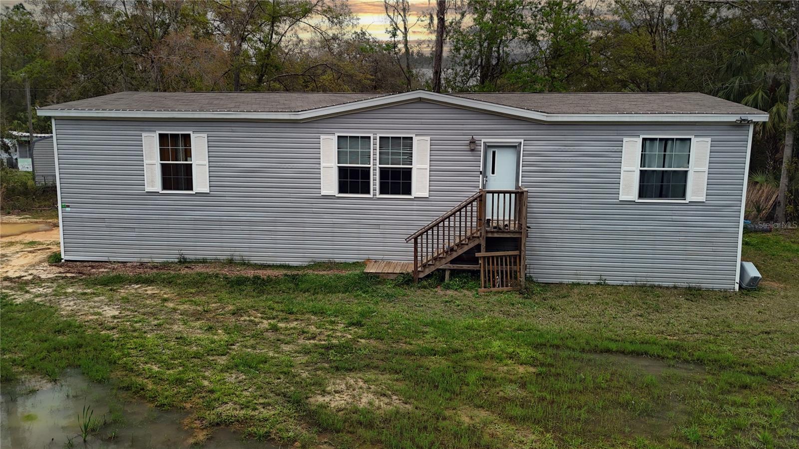 Welcome to a beautifully crafted residence, built in 2022, where modern design meets comfort and convenience. This home, nestled on a generous lot size of .43 acres also comes with a chicken coop for your farm fresh eggs in the morning for breakfast.  Step inside to discover a spacious interior of over 1,800 square feet, thoughtfully laid out to maximize both form and function. The heart of this home is undoubtedly its kitchen, equipped with essential appliances including a dishwasher, range, and refrigerator, all designed to cater to your culinary adventures. The luxury vinyl flooring throughout the house not only adds an element of elegance but also ensures ease of maintenance. The living spaces are designed with your comfort in mind, featuring an over-sized central air conditioning and central heating, keeping the ambiance perfect regardless of the season. The family room is the perfect focal point for all gatherings without the worry of upkeep. Boasting three cozy bedrooms, each space is crafted to provide a serene retreat from the day's hustle. All closets are very spacious, presenting a unique opportunity to customize storage solutions to your taste. The two bathrooms complement the bedrooms, ensuring convenience and privacy for residents and guests alike. Outdoor living is equally inviting, with plenty of room for a pool and a garden. The entire perimeter of the property is surrounded by trees, while the entire interior of the property is completely cleared, making it the perfect oasis with plenty of privacy. The inclusion of a well and septic tank for water and sewer needs, respectively, add an element of self-sufficiency to the property. This residence, devoid of a homeowner's association, offers freedom from monthly fees and the flexibility to personalize your living experience without the constraints often found in managed communities. Embrace the opportunity to make this house your home, where every detail is designed with your comfort and lifestyle in mind. Welcome to a space where every day promises the comfort of modern living, nestled within a serene and inviting environment.