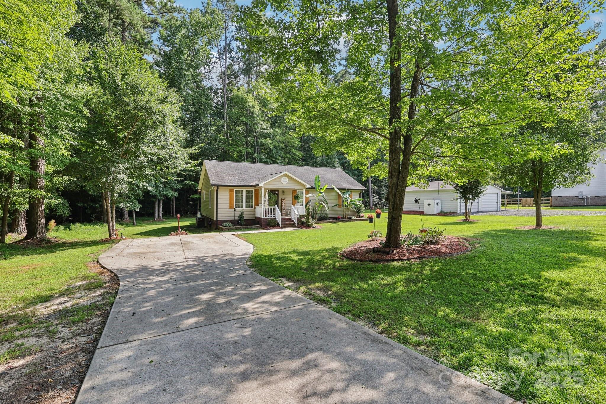 Rare Find in Gated Woodrun: Lake Tillery Access Home with Ultimate Workshop & RV Storage!

Welcome to your serene retreat nestled in the highly coveted, gated community of Woodrun on Lake Tillery. This cozy 3-bedroom, 2-bathroom home is perfectly situated on a peaceful cul-de-sac, offering both tranquility and privacy on a generous .756-acre lot. Residents here enjoy a privileged lifestyle with full access to unparalleled lakefront amenities.

The home itself presents a seamless blend of comfort and modern updates. Step inside to find sophisticated porcelain tile flooring flowing throughout the main living areas, creating a clean, contemporary feel. The kitchen is a true highlight, featuring sleek quartz countertops and convenient under-cabinet lighting. The primary bathroom has been thoughtfully refreshed to include a spacious, updated walk-in tiled shower. Essential systems are robust and recent, offering immediate peace of mind: the HVAC system is just 3 years old and a brand-new hot water heater was installed in 2025. Exterior maintenance is simplified by oversized gutters equipped with leaf guards, and the owned propane tank fuels the cozy gas logs inside. Unwind or entertain on the large covered deck overlooking the expansive, private yard.

This property is a dream come true for the hobbyist, mechanic, or collector, featuring a massive 23' x 28' workshop that includes two large 10' x 7' bay doors, electricity, plumbing, and a wood stove. Storage abounds with an additional 11' x 29' lean-to off the shop, a separate storage shed with its own lean-to, and—the highlight for outdoor enthusiasts—a dedicated 14' tall by 30' long camper carport, providing protected storage for your RV or boat. Parking is plentiful with a substantial concrete driveway complemented by a secondary gravel parking area.

Beyond your private haven, the Woodrun community offers an incredible recreational lifestyle. As a resident, you gain exclusive access to the lakefront clubhouse, a private boat ramp, and a stunning waterfront pool. This is more than a home; it is a meticulously maintained property that grants you immediate entry into the desirable, amenity-rich Lake Tillery community. Don't miss this exceptional opportunity for luxury, leisure, and supreme storage!