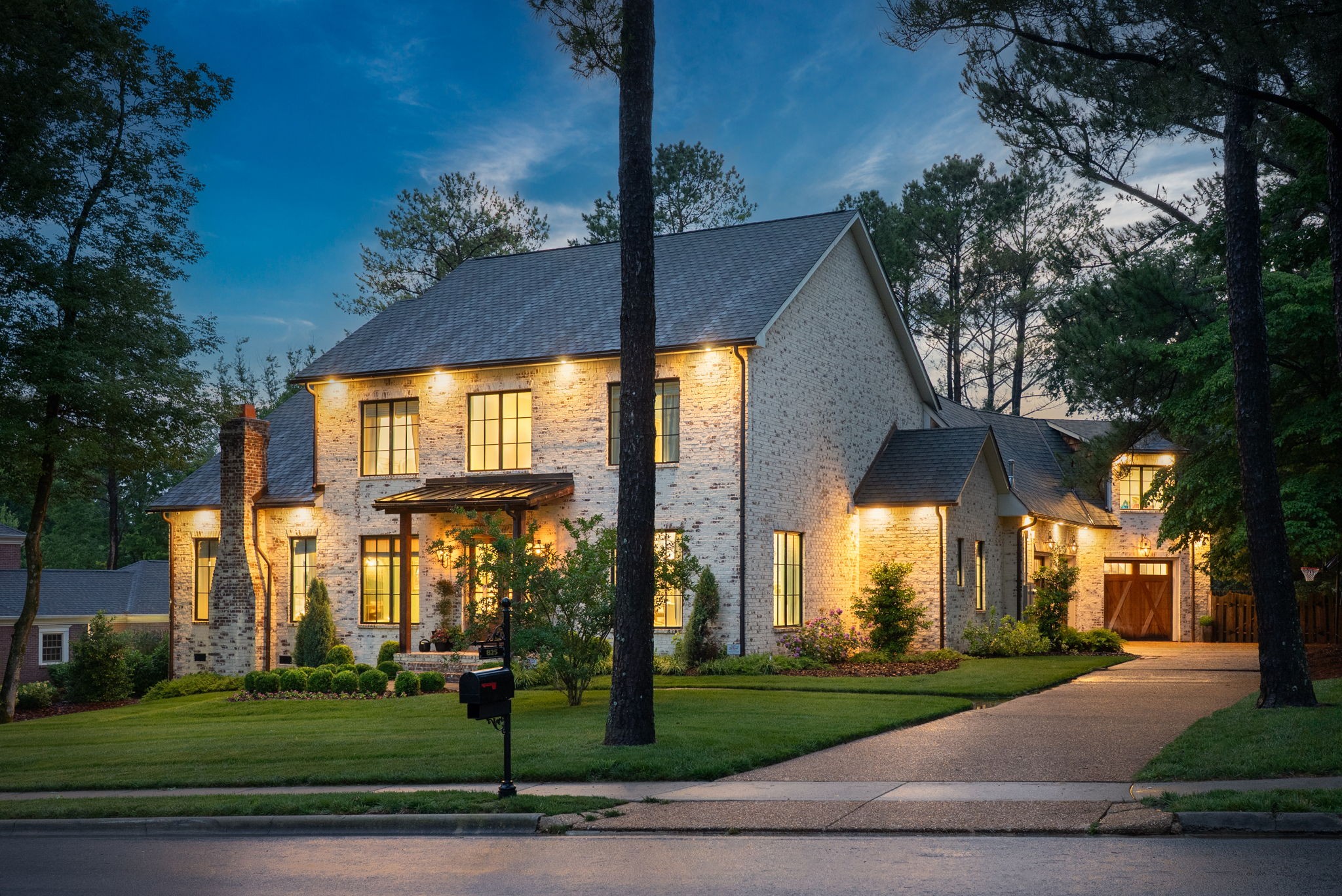 Situated in one of Clarksville's most sought after neighborhoods, Stonehenge. This thoughtfully designed home blends sophistication and practicality. Upon arrival, you're greeted with lush, well cared for, professionally designed landscaping. Natural gas lanterns, 6" OrnaMetal copper gutters, along with beautiful cedar garage doors adorn the exterior of this home. The large driveway allows ample space for guest parking or for riding bikes! The stunning interior features an open living room/eat-in kitchen as well as a formal dining room and a home office. This gorgeous kitchen is a chef's dream that includes high-end Wolf/Subzero/Cove appliances. The 6 burner Wolf gas range even has a built-in infrared griddle! Quartzite countertops, a statement vent hood, walk-in pantry with built in Elkay water bottle filler, Subzero wine fridge, and a Scotsman nugget ice maker take this kitchen to a different level. Off the living room is a large sun room with 2 walls of glass accordion doors that can be opened to the living room AND the back patio for a true indoor/outdoor experience. The main floor owner suite features a limestone gas fireplace, vaulted ceilings, and his/her walk-in closets. Your feet will never get cold at night since the primary bathroom offers heated tile flooring throughout including inside of the spa like steam shower. The second floor features 3 very large bedrooms, all with very large walk-in closets, including a Jack and Jill full bathroom, and a second full bathroom. There is a massive bonus room that spans the length of an equally large 3 car garage. There is a second floor laundry room in addition to the beautifully designed 1st floor laundry/mud room. The back yard is a 3 tiered entertainer's paradise with space for multiple tables, games, or whatever you can dream up. There is still plenty of green space to run around as well as a freshly mulched play set area. Space meets coziness and luxury meets functionality in this one of a kind home.