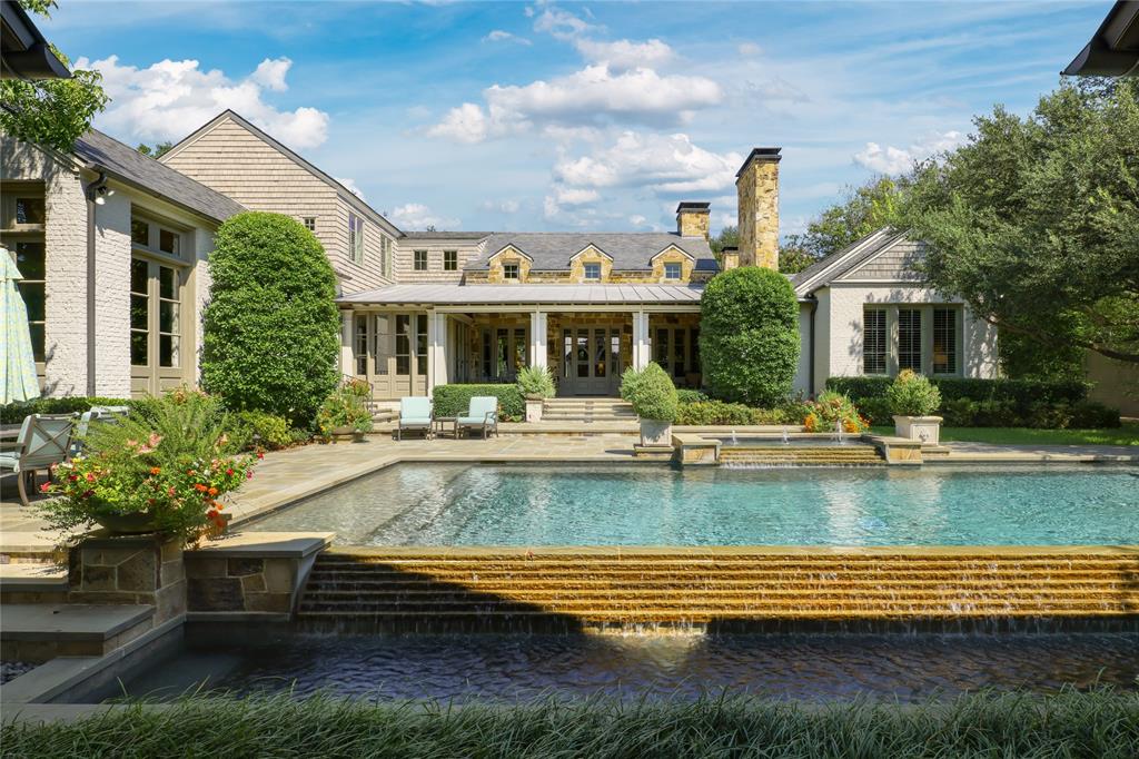 Nestled on one of old Preston Hollow’s most prestigious streets, 5722 Park Lane offers 7,998 square feet of refined living with timeless architectural detail and thoughtful design. The home features spacious formal living and dining rooms, along with inviting family spaces. A chef’s kitchen anchors the heart of the home, opening seamlessly to casual living and entertaining areas. The first-floor primary suite is complete with a spa-inspired bathroom and expansive his and hers closets. The first floor features an additional bedroom with an en-suite bathroom. Three additional bedrooms upstairs are generously sized providing flexibility for family and guests. Outdoors, the property features a large screened in porch, sparkling pool, and covered cabana ideal for year-round entertaining and relaxation.