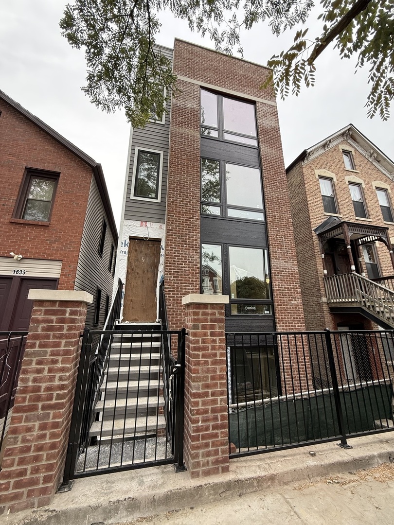 Luxurious and massive NEW CONSTRUCTION 4BD/3.1BA DUPLEX DOWN by a renowned luxury builder-delivering ~2,200 square feet of single-family scale living with 2 private outdoor spaces in a boutique three-unit building in prime Pilsen.     This home perfectly balances urban convenience and tranquil residential living. Tucked on a quiet, tree-lined street, yet steps from the vibrant 18th Street corridor, you'll enjoy award-winning restaurants, nightlife, galleries, and concerts at your doorstep. Excellent location that's close to everything - Damen and 18th Pink Line stops, Western Metra stop, Expressway, Lakefront, Harrison Park,  and more.     Set within a striking masonry and Hardie exterior, this home lives like a single-family residence. The main level showcases oversized windows, 9' ceilings, and a chef's kitchen equipped with custom cabinetry, high-end quartz countertops, a 10-foot island, premium KitchenAid stainless steel appliances, a full-size pantry, and a breakfast nook-all anchored by custom millwork that flows into the spacious living and dining areas, making it perfect for entertaining. The rear of the main floor has a bedroom + full bathroom, powder room, an XL coat closet, and a large tiled mudroom. Wide-plank white oak flooring runs throughout, enhancing the clean, modern aesthetic.     On the lower level, the large, serene primary suite features a spa-quality bath with an oversized walk-in shower, a 9-foot double vanity with white oak cabinetry, and an enormous walk-in closet. Two additional bedrooms on the lower level provide versatile options for family, guests, or a home office, while the in-unit laundry, tons of storage space, and private rear deck add convenience to everyday living. Smart thermostat, keyless entry, and one dedicated parking space included. With exceptional scale, refined finishes, and a prime location near transit and culture, this one-of-a-kind home presents a rare opportunity in one of Chicago's most vibrant neighborhoods.