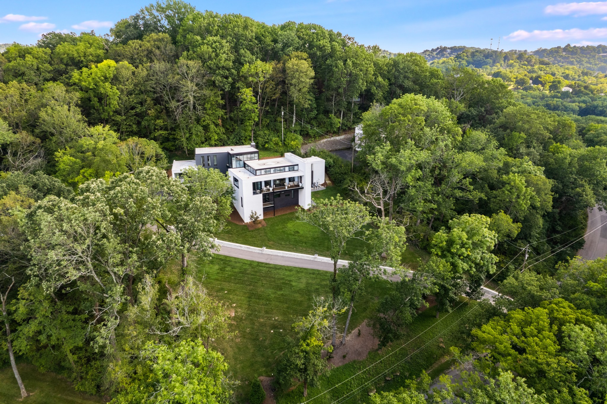 Modern Luxury Meets Historic Prestige at this Shy’s Hill Luxury Hillside Private Estate.  Perched adjacent to the legendary grounds of Shy’s Hill monument, this extraordinary modern residence stands as one of Nashville’s most distinctive homes. Perfectly positioned in the heart of Green Hills, you’re moments from 12South, Downtown, Belle Meade, Brentwood, and the city’s finest dining, shopping, and culture. Every detail of this 5-bedroom, 5 full 2 half-bath home has been masterfully curated, blending refined design elements from designers ASR Studios in NYC and Southern Modern in Nashville. Highlights include - custom elevator servicing all levels, climate-controlled wine vault, resort-style pool with hot tub, pool bath, outdoor kitchen, and full privacy, expansive nano doors for seamless indoor-outdoor living, dedicated home office with natural light & fireplace, breathtaking sunset views, bespoke handcrafted primary suite closets and custom cabinet upgrades throughout, custom designed media / music room with Bang&Olufsen system. Enjoy private views from all vantage points inside out through floor to ceiling windows. Showings by appointment only. Proof of funds required. Serious inquiries may contact listing agents for further details.