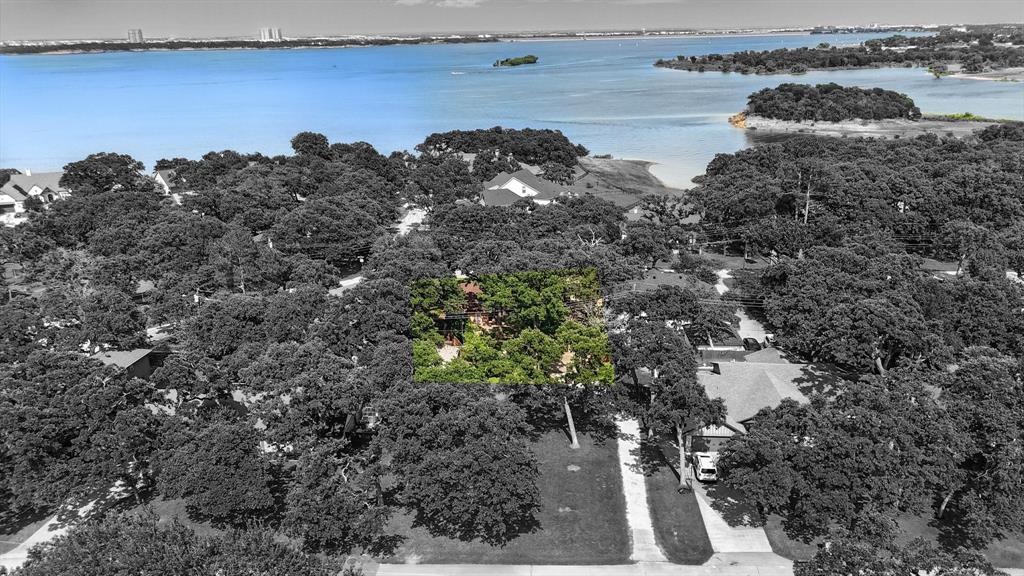 Welcome to Lake Forest Addition, One of Grapevine’s Most Sought-After Lake Communities! This rare and unique property offers a true lake lifestyle including a deeded BOAT SLIP just steps away! Situated on a generous .28 acre lot. Enjoy partial lake views of Grapevine Lake from the front of the home and imagine even more breathtaking vistas with the addition of a second story. The lot has shade with mature trees, creating a serene and private atmosphere.The home offers 3 bedrooms, 2 bathrooms with a thoughtful split-bedroom layout. Two spacious living areas, ideal for entertaining, a game room, or a flex space. Beautiful hardwood floors in the main living and dining areas, hallways, and one bedroom. Semi-updated kitchen and baths a backyard retreat featuring a large concrete patio, pergola, 2-car carport with workshop space. This home includes your own deeded BOAT SLIP at the private community marina – a luxury that rarely comes available in this neighborhood. Whether you’re looking to enjoy as-is or
explore future development potential, the endless possibilities and premium location make this a truly special offering. The lot behind the home is also for sale and can be purchased together or separately. The address of the rear lot is 3512 Lakeridge Dr. Parcel ID 01546945. Reach out for more info or schedule a showing!