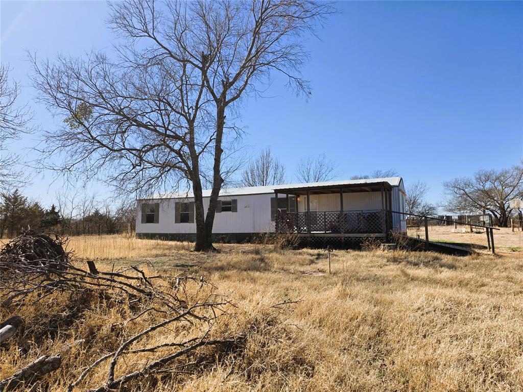 Need a weekend getaway by Lake Thunderbird? This updated 2-bed home on 2+ acres has privacy, outdoor space, and homestead-ready features. Discover the perfect blend of modern comfort and country living on this 2.02-acre retreat. This home features a spacious, open-concept kitchen with brand-new cabinets that flows seamlessly into the living area—ideal for hosting friends and family. The interior boasts fully renovated bathrooms and new steel doors leading to expansive front and back decks. Outside, the property is ready for your homesteading dreams, complete with a chicken coop, storage building, and sand plum trees perfect for homemade jam. Peace of mind is built-in with an outdoor storm shelter and a carport for vehicle protection. Located just minutes from Lake Thunderbird, this quiet sanctuary offers the privacy you crave with the modern updates you deserve. Affordable path to homeownership with land. Move-in ready 2-bed home on 2+ acres. Room for pets, gardening, storage, and outdoor living. HOA Fee is for yearly road maintenance only. This may need an inhouse mortgage due to not being on a permanent foundation