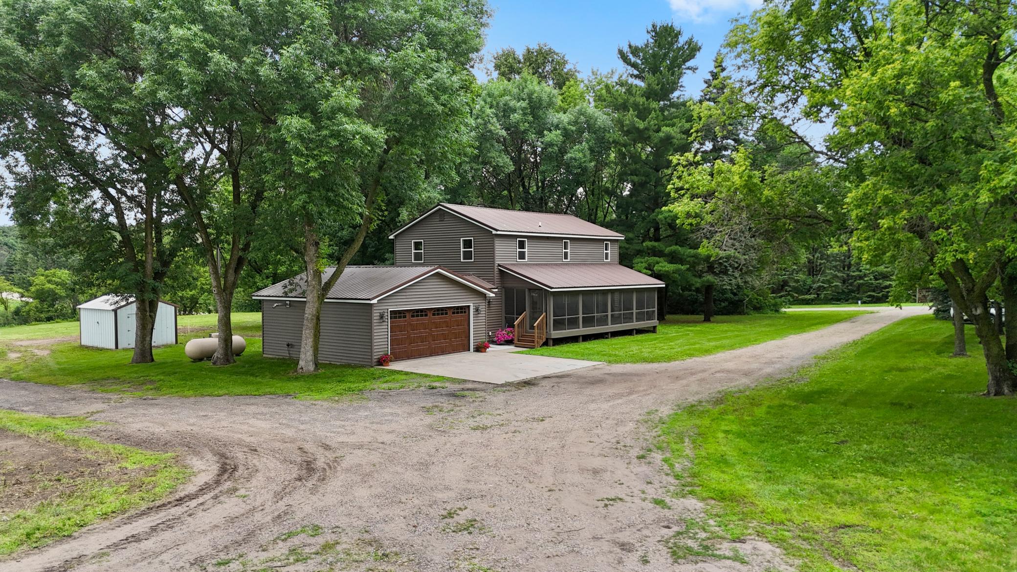 Located on the edge of town on 3 private acres, this completely remodeled home offers the perfect blend of country living and convenience. Featuring 4 same-floor bedrooms and 3 bathrooms, the home has been updated inside and out with new vinyl siding, new windows, new exterior doors, new trim and interior doors, a beautifully remodeled kitchen with stainless steel appliances, updated bath fixtures, and mostly new flooring while preserving the original hardwood floors. The HVAC system is just 2 years old, adding to the home's long list of recent improvements. Additional features include main-floor laundry a spacious 10x36 screened front porch and attached finished heated garage.  Outside, you'll find a 30x48 outbuilding with two lean-tos, a 12x16 storage shed, and plenty of room to enjoy the outdoors. Located just minutes from town and the area's many lakes, this move-in-ready property offers the best of country living with modern updates.