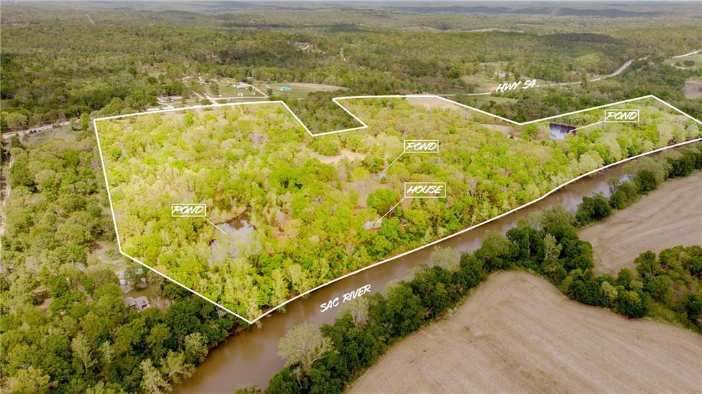 83+ Acres Overlooking the Sac River | Historic Cabin | Prime Recreational RetreatThis is the kind of property people wait years to find.Spanning 83+ acres with sweeping views, along the half a mile plus of the Sac River, this tract offers a rare blend of history, privacy, and usability. The land lays beautifully with a mix of timber, open ground, and natural habitat—ideal for hunting, fishing, trail riding, or simply getting off the grid. There are a total of five ponds on the property. There are three large ponds that offer ample opportunity for fishing, two of which are spring fed with crystal clear water year round. The other two smaller ponds serve to provide water for the abundant wildlife. Much of the open ground is planted in native prairie grass. Close to a third of a mile of bluffs overlooking the river provide plenty of opportunities to build a new home or just enjoy the views. You'll often get to enjoy the sights and sounds of Bald Eagles soaring or fishing on the river and most every night the owls and whippoorwills will sing you to sleep.. and the stars!!Tucked into this landscape sits a charming cabin originally built in the 1800s. A cozy, rustic cabin where you can curl up next to the fire or sit out on the deck overlooking the river and the valley beyond. It’s the perfect basecamp for weekend escapes—or a full-time residence if you’re ready to trade noise for nature.The views are the real showstopper—elevated vantage points overlooking the river valley create a setting that feels expansive, peaceful, and completely yours.Whether you’re looking for a hunting/fishing property, recreational getaway, or a private homestead with history and soul, this one delivers.Highlights:83+ acres overlooking the Sac RiverOver 1/2 mile plus of river frontageCharming historic cabin (1800s origin)Excellent hunting, fishing, and wildlife presenceScenic views and rolling terrainIdeal for recreation, weekend retreat, or full-time living