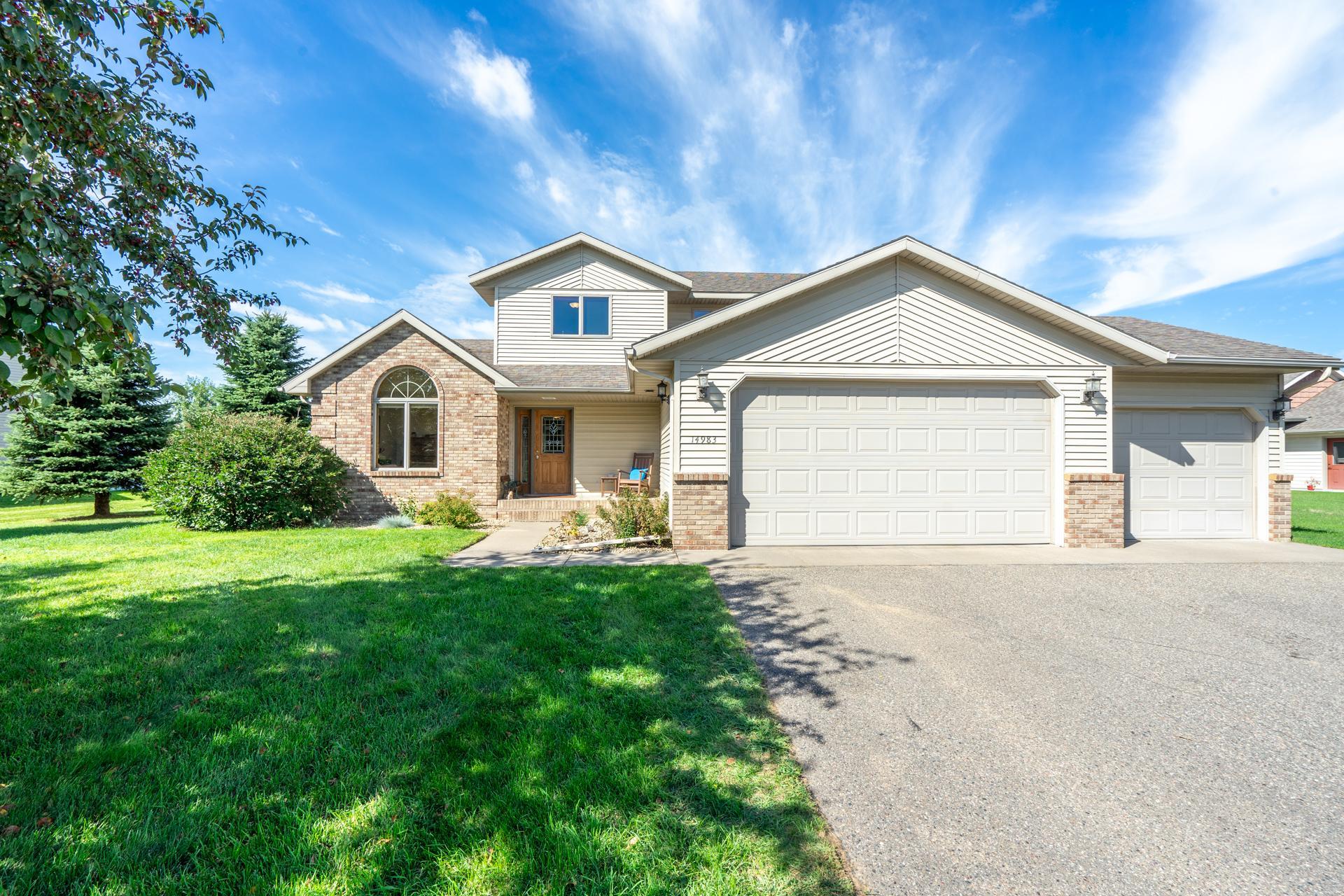Welcome home to this spacious 2006-built modified two-story! It is conveniently located yet tucked away for complete privacy. Step into a sunlit, two-story great room anchored by a floor-to-ceiling stone gas fireplace and an open staircase leading upstairs. The main level features a private owner's suite with a walk-in closet and jetted tub, a bright kitchen/dining combo, a flexible front bonus room perfect for a home office or additional space that you may need, main-floor laundry, and a guest half bath.Upstairs, find three generous bedrooms and a full bath. The full basement is ready for your finishing touches, already stubbed for a bath with an egress window for a 5th bedroom, or offers endless storage space. Complete with an insulated and heated 3-car garage, a cozy patio, and a fully fenced yard kept green with an irrigation system. You do not want to miss out on this one!