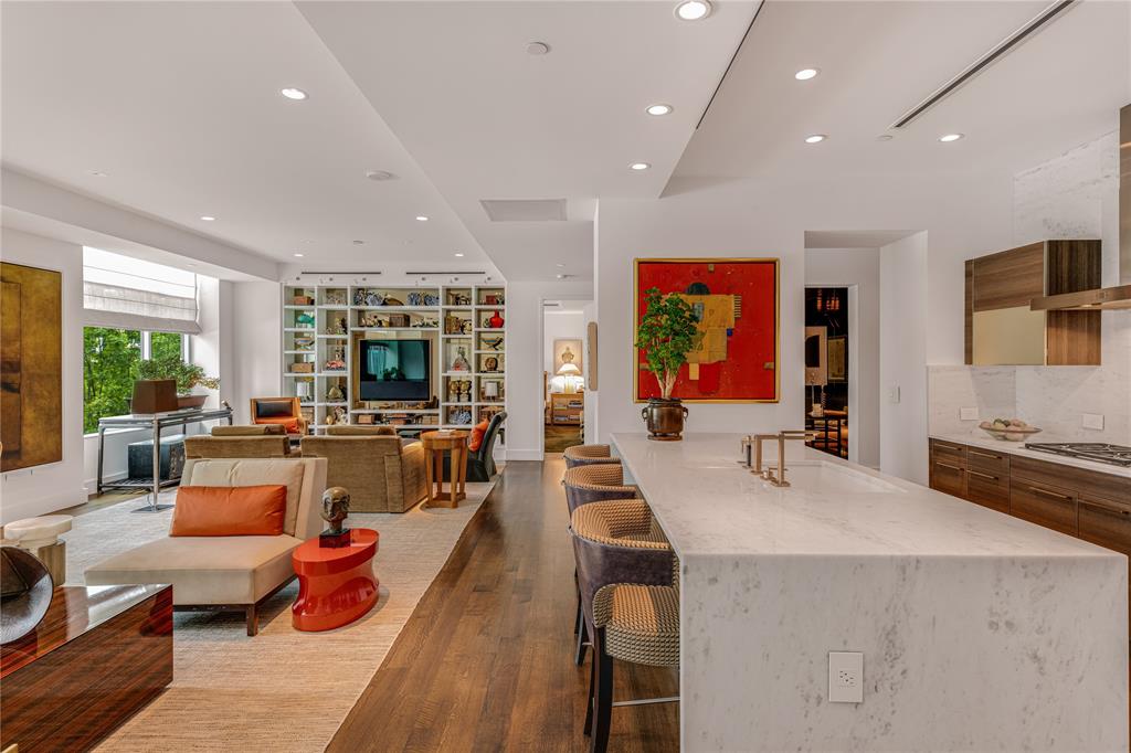 This magnificent George Cameron Nash-designed condominium offers masterfully crafted architectural elements along with extraordinary interior finishes throughout. Enjoy sweeping views of the downtown Dallas skyline, the Dallas Arts District, and Klyde Warren Park. The home features tall, coffered ceilings, spacious open rooms, two terraces, and abundant natural light. Stroll to amazing restaurants, museums, sculpture gardens, theatre, and shops. Two large, airy bedrooms with ensuite baths, two magnificent living areas, a drinks room, gourmet kitchen, powder room, amazing closets, and a large laundry room. Located in Parkside, an exclusive mid-rise boutique building with only ten residences, this beautiful home has newly installed whisper-quiet windows, motorized custom draperies and shades, new HVAC, secure access, a spacious rooftop entertaining area, two reserved parking spaces, an oversized private storage unit, and much more. Many custom-designed design elements included. Stunning!