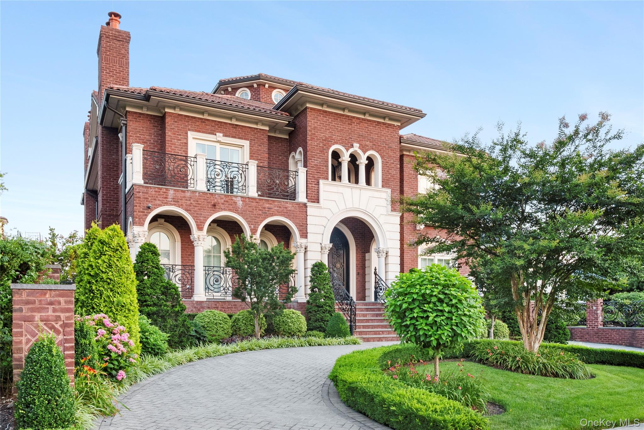 Nestled within the prestigious waterfront enclave of Malba, one of Queens’ most exclusive neighborhoods, this exceptional custom-built estate showcases timeless European-inspired architecture, modern luxury, and resort-style living just 25 minutes from Manhattan.Beautifully crafted with elegant stone detailing, graceful arches, custom wrought-iron railings, and a classic clay tile roof, the home welcomes you with a dramatic 40-foot grand foyer and a private elevator serving every level.This sophisticated smart home offers six bedrooms, six full bathrooms, three fireplaces, expansive living spaces, radiant heated floors throughout the first level, all second-floor bathrooms, and the finished lower level, as well as a whole-home surround sound system.Designed for effortless indoor-outdoor living, the resort-style backyard features a smart-controlled saltwater pool, outdoor BBQ kitchen, and an elegant limestone patio framed by architectural arches. An expansive second-floor terrace provides additional space for relaxing and entertaining.Set on one of Malba’s most desirable streets, this distinguished residence offers a rare opportunity to own an exceptional home in one of New York City’s premier waterfront communities.