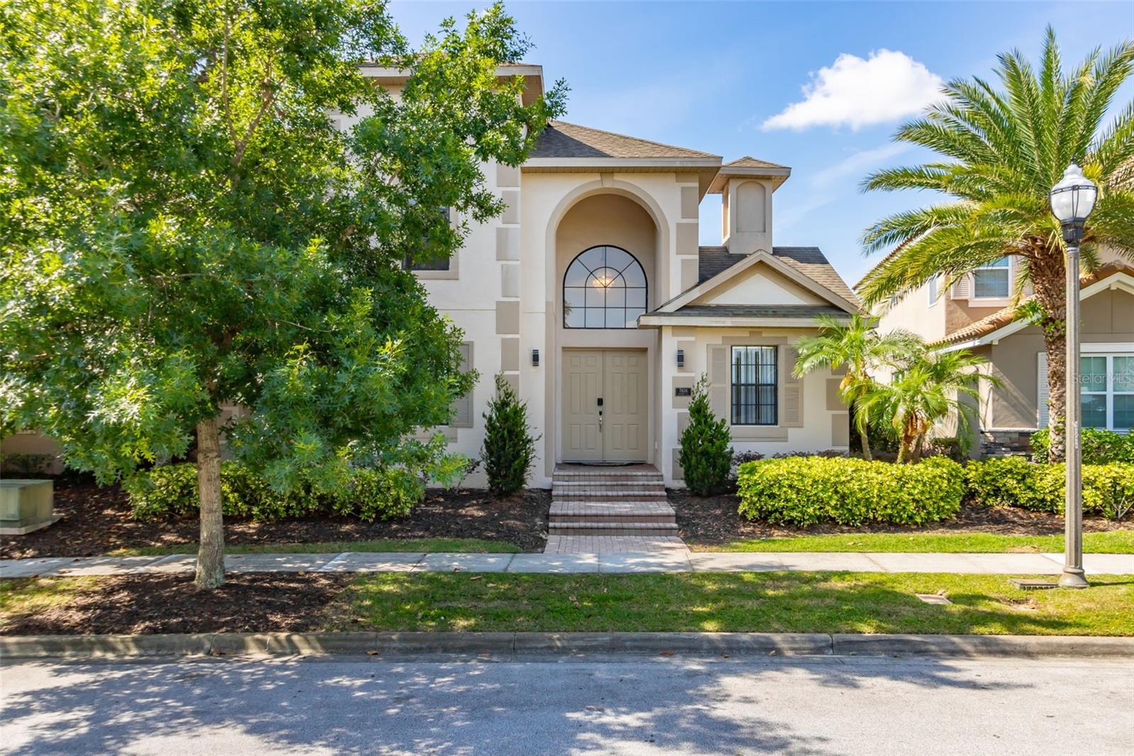 Experience resort-style living in this beautifully updated pool home, ideally situated in the heart of Reunion Resort’s sought-after Homestead neighborhood. Just steps from the community’s many restaurants, pools, and recreational amenities, this residence offers the perfect blend of luxury and comfort.

The main level features striking white porcelain tile throughout and centers around a private, heated courtyard pool with desirable south and west exposure. Sunlight fills the spacious interior, highlighting standout features in every room—from the elegant living area with a vibrant electric fireplace, to the modern island kitchen outfitted with premium energy-efficient ZLine appliances, quartz countertops, breakfast bar, and direct pool access via sliding doors.

Enjoy meals or entertaining in the stylish dining room with an adjacent sunlit sitting area. The first-floor primary suite is a true retreat, complete with a spa-inspired bath offering a rain shower, soaking tub with ambient lighting, double vanity with quartz finishes, and a custom walk-in closet with built-ins—all accented in soothing gold and white tones. A second en-suite bedroom on the main level also opens to the pool, ideal for guests or multigenerational living.

Upstairs, two additional bright and generously sized bedrooms each feature updated en-suite baths, while a versatile loft area currently functions as a gaming lounge but could easily serve as a home office or study.

This well-maintained home includes numerous recent updates such as pool resurfacing, a new deck, and a brand-new AC unit. Offered furnished with stylish, brand-new décor (optional), the property is move-in ready—perfect as a primary residence, vacation retreat, or income-producing rental.

The HOA covers lawn care, high-speed internet, and HD cable, and residents enjoy access to Reunion’s outstanding amenities including fitness centers, pools, restaurants, and more. Located just 6 miles from Walt Disney World® and about 30 minutes from Orlando International Airport, this home delivers exceptional value in an unbeatable location.