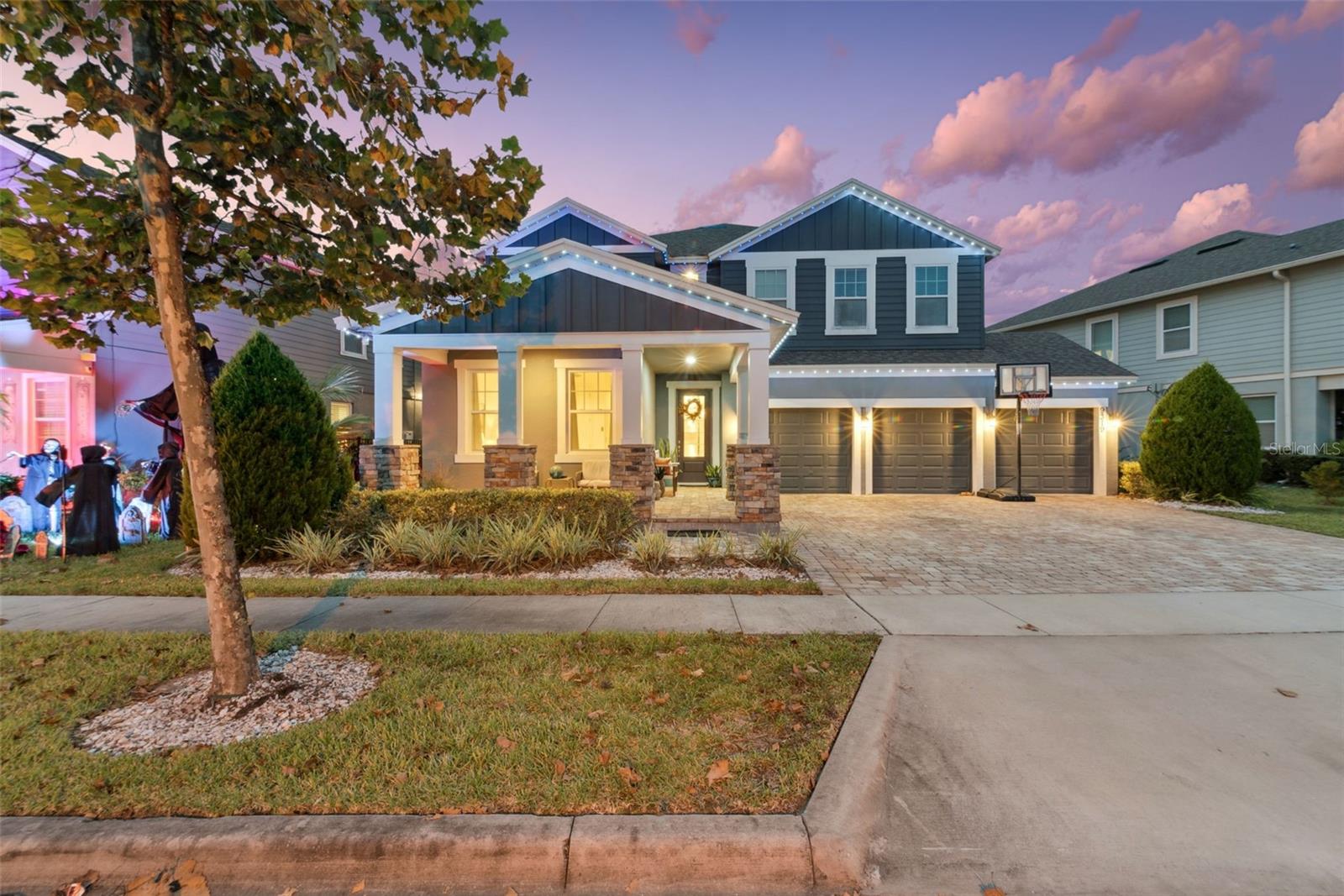 Beautifully appointed 5 bedroom 4.5 bath home located in the desirable Latham Park community.  This home boasts designer features throughout; including gourmet kitchen, quartz countertops, elegant stonework, and recessed exterior LED lighting, just to name a few. Enjoy relaxing evenings in the spacious fenced in yard overlooking the scenic pond.  The community amenities include pool, clubhouse, playground, and walking paths.  Conveniently located near theme parks, shopping, dining, and SR 429.