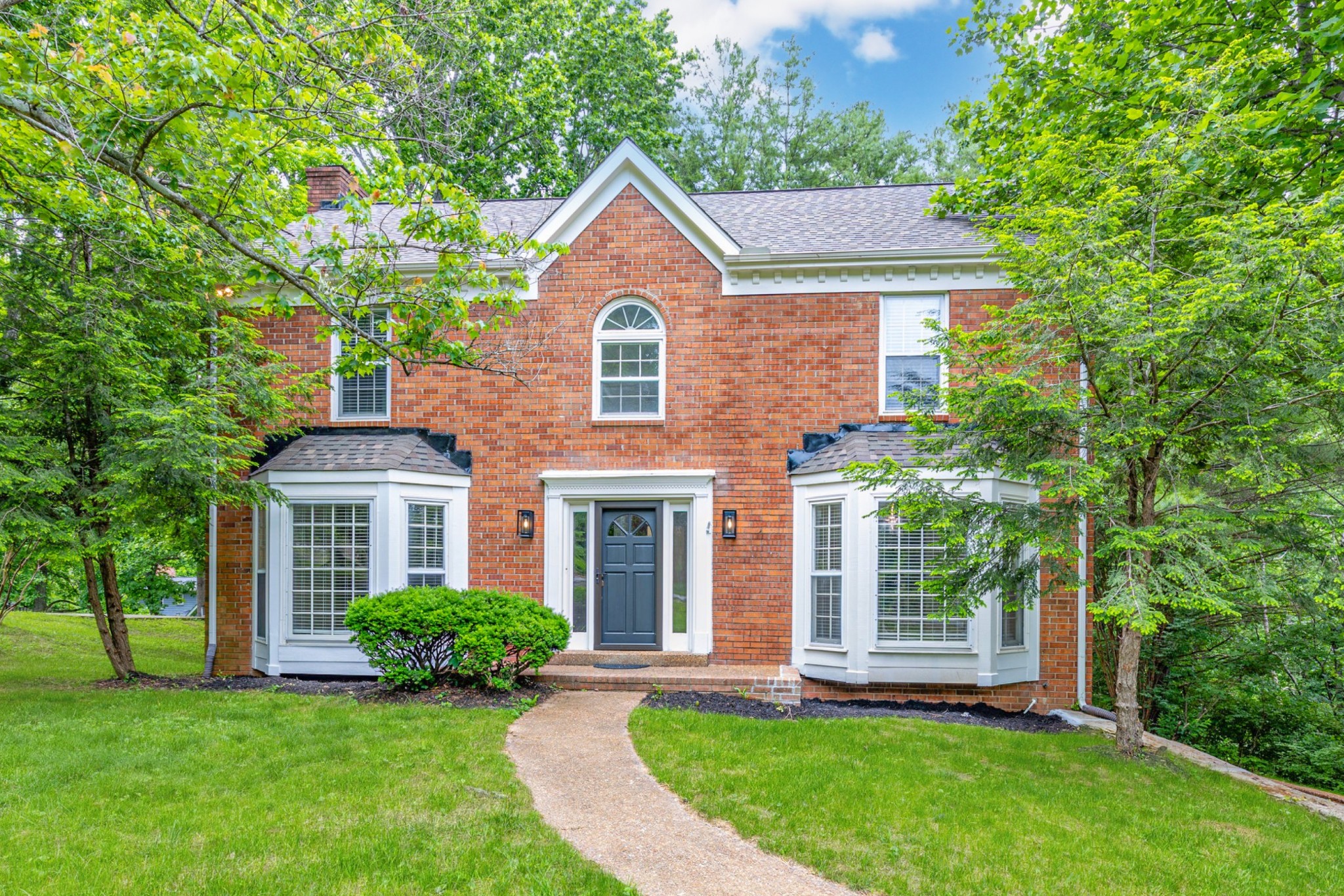 Welcome to 6933 Southern Woods Dr — one of the most affordable single-family homes in Brentwood (Williamson County)! Zoned for top-rated Brentwood High School, this charming all-brick home offers a rare blend of privacy, space, and value.  Inside, you'll find fresh paint, updated light fixtures, new LVP flooring, and refinished hardwoods in the entryway. The spacious living room features a cozy wood-burning fireplace and beautiful bay windows, while the kitchen provides plenty of cabinet space and natural light. Each bedroom includes a generous walk-in closet for ample storage.  Downstairs, a full unfinished basement offers over 1,100 square feet of potential — perfect for a future home gym, bonus room, or workshop. Step outside to a peaceful back deck overlooking a tree-lined 0.52-acre lot, ideal for relaxing or entertaining.  This home is not in an HOA – however, you can still enjoy optional access to the community pool, tennis courts, playground, and walking trails. Move-in ready with room to customize — this Brentwood gem won’t last long!