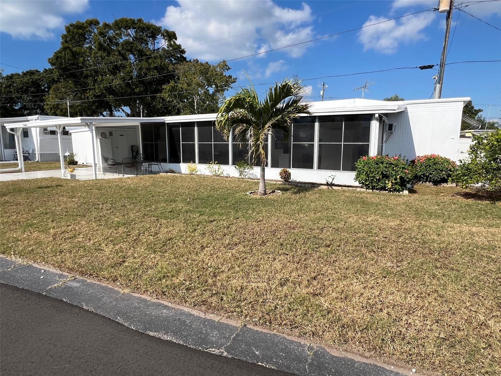 Oasis—that’s exactly what comes to mind when you see this appealing new listing in the well-kept Oasis Mobile Home Park. This pleasant 2-bedroom, 1.5-bath home is part of a friendly 55+ community where an incredibly low $143.00 monthly maintenance fee covers water, sewer, garbage, and lawn service, making everyday living a breeze. Enjoy the welcoming atmosphere as you gather with neighbors in the community center or challenge friends to a lively game of shuffleboard. It’s a comfortable, effortless lifestyle waiting to be enjoyed.INTERIOR:Begin your tour of this meticulously remodeled home - presented in excellent condition, offering a clean, bright, and fully furnished environment designed for easy living. Modernized windows, ceiling fans, a wall unit, and a split bedroom floor plan tailored for practical comfort. Laminate flooring and paneled walls extend throughout most of the residence, complemented by vinyl floors in the 1.5 bathrooms. The updated eat-in kitchen provides ample cabinetry, and the engaging living room features abundant windows on both sides, maximizing natural light. One bedroom serves as an ideal guest suite with a private half en suite bath and built-in closet drawers, while the second bedroom includes two closets, each outfitted with lower drawers and additional storage between them. The spacious main bathroom includes a generous vanity with extensive drawer space and a walk-in shower to ensure easy accessibility.EXTERIOR:You’ll be drawn to this home’s curb appeal with its bright white aluminum exterior, awnings, and tasteful landscaping, but it’s the expansive lot that truly enhances the sense of privacy. A charming seating area sits just off the 2-car carport, and stepping into the Florida room gives you that wonderful indoor/outdoor experience with vinyl plank flooring, air conditioning, and windows all around—each equipped with roll-down blinds. There’s generous space and seating to relax and entertain, plus a roof-over and a shed that houses the washer and dryer, making laundry day effortless. Priced at a fantastic $75,000, including the share, this inviting property won’t last long. Call for your private showing and start enjoying life in your very own “oasis”!