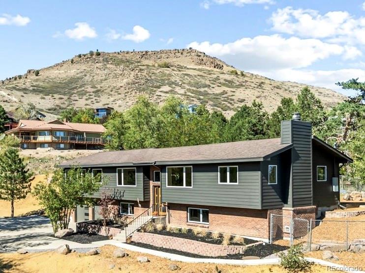 UNIQUE NORTH TABLE MOUNTAIN MASTERPIECE. 4,000 square feet of living space in an incredible Golden foothills setting. GORGEOUS FINISHES: Hardwood floors throughout the main level, solid single-panel doors, natural stone countertops and backsplash, solid wood cabinetry and brushed-gold fixtures create a warm, sophisticated interior. DETACHED GARAGE + BONUS ROOM: In addition to the two-car attached garage, the property includes a separate two-car garage with a finished bonus room above—perfect for a home office, studio, gym or kids' hideout. The detached garage has its own address at 4195 Easley Road. HUGE LOT: More than half an acre cascading down North Table Mountain, with multiple opportunities to create incredible outdoor living spaces. There's room to garden, entertain, play—or even keep horses, as neighboring properties do. FUNCTIONAL FLOOR PLAN: The huge open-concept main level centers around the kitchen and great room, with the primary suite and additional bedrooms all on the main floor. Downstairs you'll find another family room, office and guest room, while the spacious laundry room offers abundant storage and a built-in bench and doubles beautifully as a pantry and mudroom. IDEAL TRAILHEAD LOCATION: North Table Mountain trails are just a few hundred yards away, while downtown Golden is a quick drive or bike ride. Easy access toward Denver and the mountains makes this an exceptional home base for the Colorado lifestyle. SHOW-STOPPING KITCHEN: The centerpiece of the home features double islands, two-tone cabinetry and countertops, a 48-inch range, full-size refrigerator and freezer, plus a wet bar with wine refrigerator and dedicated ice maker. INCREDIBLE PRIMARY SUITE: An oversized bedroom is complemented by a separate workout room or office, an enormous walk-in closet with washer/dryer hookups ready for customization, and a dramatic bath with expansive vanity space, dual showers, freestanding soaking tub and private water closet.