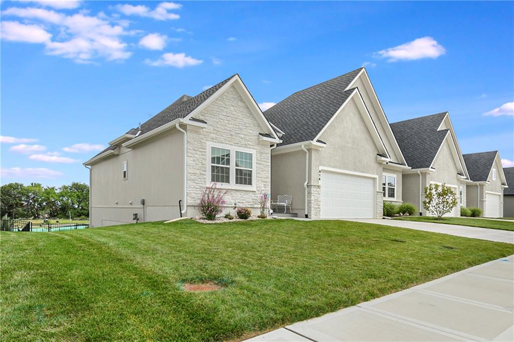 Welcome to Low-Maintenance Luxury! Why wait to build when you can move right into this pristine, two-year-young luxury villa that boasts every upgrade and extra imaginable? Enjoy effortless main-level living combined with the ultimate peace of mind—your HOA takes care of lawn care, snow removal, and exterior maintenance, freeing up your time for what matters most. Key Features & Upgrades: Modern Open-Concept Layout: Soaring ceilings, high-end engineered hardwood flooring, and expansive windows create a bright, airy flow throughout the main living areas. Gourmet Chef’s Kitchen: Outfitted with custom soft-close cabinetry, a massive quartz island with breakfast bar seating, premium appliances, a gas range, and a spacious walk-in pantry. Primary Suite: A serene retreat featuring a spa-inspired bath with a double vanity, a curbless custom-tiled walk-in shower, and a generous walk-in closet with direct access to the laundry room.Designer Finishes include Upgraded lighting fixtures, custom window blinds, designer accent walls, and zero-entry accessibility features throughout. Lower-Level / Flexible Space with a full walkout to a private patio. Fully finished lower level offers a large secondary living area, additional bedroom, full bath, and plenty of unfinished storage space.Outdoor Living at Its Best: Step out to a covered, screened-in patio overlooking a professionally landscaped yard—perfect for morning coffee or evening entertaining without the yard work.Smart & Energy Efficient equipped with a smart thermostat, security system, ring doorbell, high-efficiency HVAC and water heater. Immaculately maintained and better than new, this turn-key villa offers the perfect blend of modern sophistication, high-end comfort, and lock-and-leave convenience.