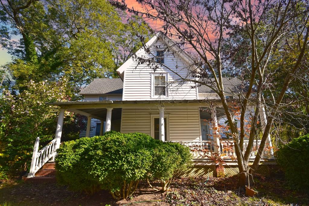 Timelesss charmer dating back to 1810, this historic home rests on 1.75 picturesque acres, offering classic character paired with peaceful outdoor living.  Large, welcoming front porch sets the tone, inviting you to slow down and enjoy the tranquil surroundings. Mature trees frame the property, creating a private, park-like setting, while expansive yard provides ample space for entertaining, gardening, or quiet moments immersed in nature. Located in heart of charming town of Eastville, home to coffee shop and local restaurant and just five miles from Savage Neck Dunes Natural Preserve, featuring 298 acres of soaring sand dunes, undeveloped beach, maritime forest, ponds, and trails. This home's rare blend of history, setting, and location truly makes it a must-see. Home is being sold as is.