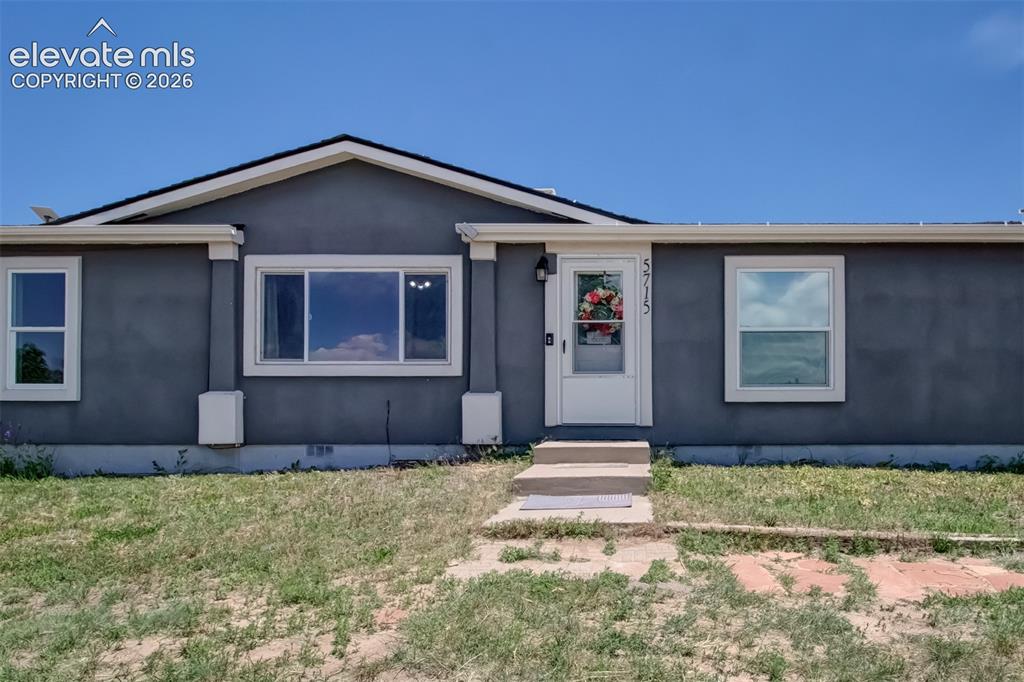 WELCOME HOME to country living with modern comfort on 2.5+ acres in desirable Southfork! This beautifully updated ranch-style home offers 4 beds, 2 baths, and sweeping mountain views. Inside, you'll find an open and inviting floor plan featuring vaulted ceilings, fresh interior paint, new carpet, updated light fixtures, custom countertops, and heated ceramic tile floors. The spacious kitchen has been refreshed with a newer refrigerator, newer dishwasher, and new vent hood, creating a functional space for both everyday living and entertaining. Multiple living areas provide room to spread out, highlighted by a charming stone fireplace that creates a warm and inviting focal point for gathering with family and friends. The enclosed sunroom offers the perfect place to enjoy your morning coffee while taking in the surrounding views year-round. Step outside to the new composite deck overlooking the expansive property, complete with play structure and hot tub wiring already in place. The oversized detached two-car garage includes a dedicated workshop area, making it ideal for hobbyists, mechanics, or extra storage. Additional features include a spacious crawl space for storage, natural gas service, community water, and paved road access—conveniences rarely found on acreage properties. Additional updates include a newer furnace and new water heater, providing peace of mind for years to come. Zoned for horses and up to 3 large animals, this property is ready for your rural lifestyle dreams, whether that includes horses, llamas, donkeys, chickens, or simply enjoying the extra space and privacy. Conveniently located with easy access to Falcon, Colorado Springs, Peterson Space Force Base, and Schriever Space Force Base, this property offers the perfect balance of country living and city convenience. Don't miss this rare opportunity to own an updated acreage property with incredible views, a workshop-ready garage, and room to live the Colorado lifestyle you've been dreaming of.