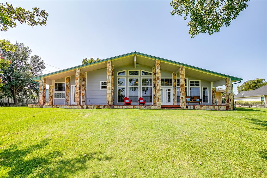 Welcome home to your Eagle Mountain Lake retreat, where every day feels like vacation. This four bedroom, four bathroom, two car garage home offers 3,190 square feet on 2.19 acres with incredible views. The kitchen is designed for entertaining with commercial grade stainless steel countertops, a gas cooktop, double oven, ice maker, trash compactor, and garbage disposal. A large pantry, spacious laundry room, and abundant storage throughout the home add everyday convenience. The primary suite includes dual vanities, a steam shower, jacuzzi tub, and huge his and hers walk in closets. The fourth bedroom functions perfectly as an in-law suite or a second primary. Two of the bedrooms include Murphy beds for flexible space.

Step outside and fall in love with the expansive back porch overlooking the water. It is the perfect spot to watch the sunrise with your morning coffee or host friends while taking in breathtaking views. Inside you can cozy up by the fireplace, or enjoy lake living at its finest outdoors.

The dock includes a boat lift and two jet ski lifts, while the sprinkler system is conveniently fed from the lake. Three shops provide endless possibilities, including one with a finished office ideal for working from home. A circle drive with electric gates at both ends adds security and convenience. Located outside city limits and within walking distance to the marina and restaurant, this property combines privacy and lifestyle.

Whether you are looking for a full-time lake residence or a weekend getaway, this is the one for you.