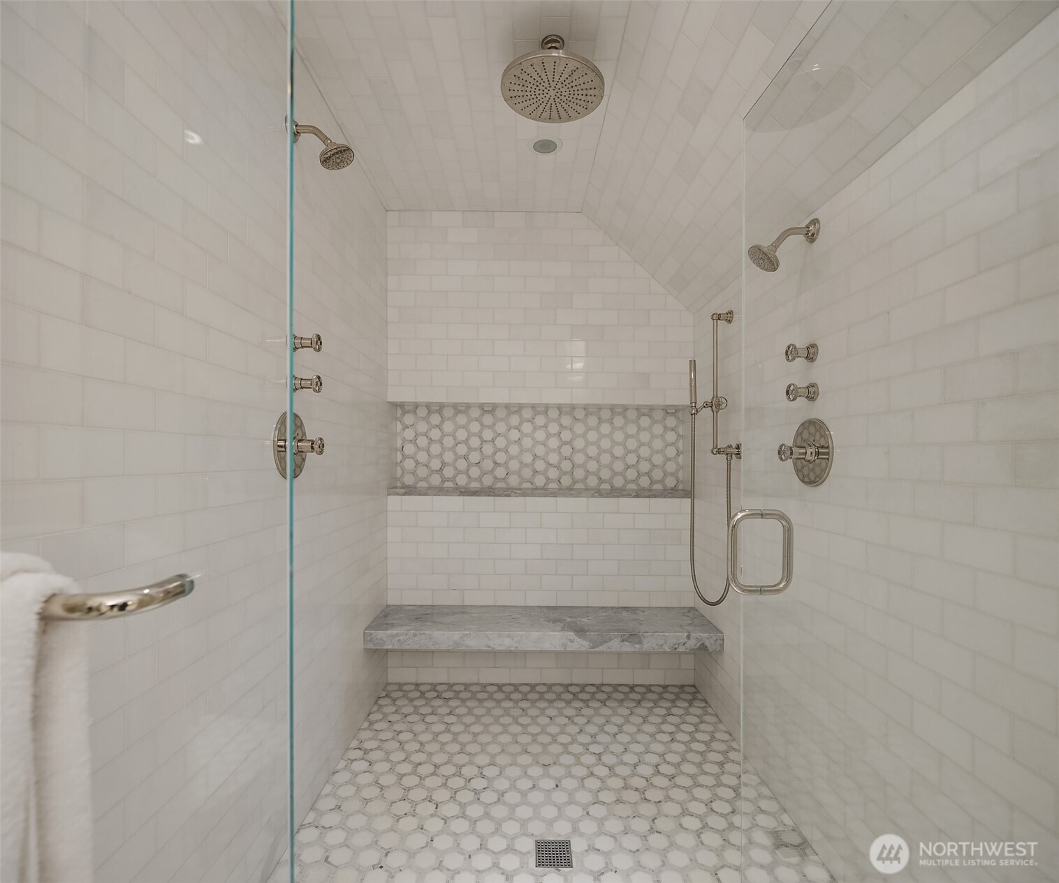 Marble-tiled shower completes the primary bath