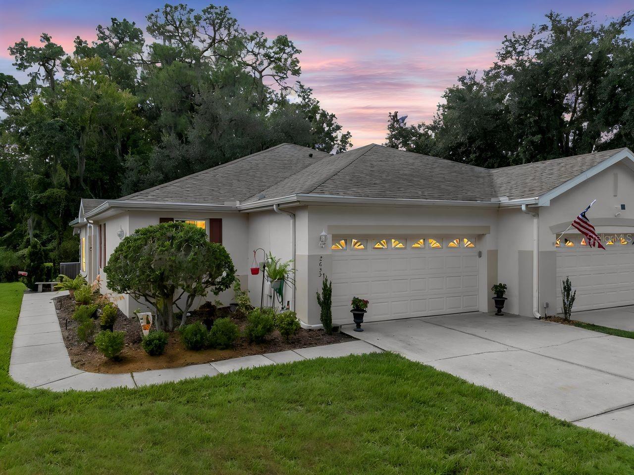 A peaceful green-space backdrop, a sunlit Florida room, and a home in the gated boutique community of Eagle Greens within the master-planned Walden Lake community make this Plant City home worth a closer look. Located at 2635 Eagle Greens Drive, this single-story, villa-style condominium offers two bedrooms, two full bathrooms, 1,236 square feet of heated living space, and an attached two-car garage. An open-concept floor plan, no rear neighbors, and no CDD fee bring together everyday convenience and a setting you can enjoy from morning coffee to the end of the day.Mature landscaping frames the approach, with a side walkway leading to the entrance. Inside, luxury vinyl plank flooring connects the kitchen, dining room, and living room for a cohesive flow. The kitchen features generous cabinet storage, decorative shelving, a double sink, and a breakfast bar that keeps conversation close while meals come together. A front-facing window brightens the dining area, while the living room draws your attention toward the greenery beyond.Sliding glass doors open to the covered, enclosed Florida room, where tile flooring, a ceiling fan, and surrounding windows create an inviting place to read, unwind, or enjoy the rear outlook. The primary bedroom also overlooks the green space and includes a built-in closet and an en-suite bathroom with a walk in shower. The second bedroom sits beside a full bathroom with a tub and shower combination, providing flexibility for guests or a home office. A utility sink and pull-down attic access add practical convenience to the two-car garage.Set on a no-outlet street within boutique Eagle Greens, part of the broader lifestyle of the established Walden Lake master-planned community. Association services include water, landscaping, roof maintenance, exterior maintenance and pool exclusive to the residents of Eagle Green. Walden Lake offers walking trails, park space, sports fields, and a resident dog park.Beyond the neighborhood, discover Historic Downtown Plant City’s local shops and restaurants, the celebrated Florida Strawberry Festival, and regional access to Tampa and Lakeland. From its easy-flowing interior to its light-filled Florida room, this home offers a compelling combination of space, setting, and Plant City convenience. Schedule your private showing and experience Eagle Greens at Walden Lake.