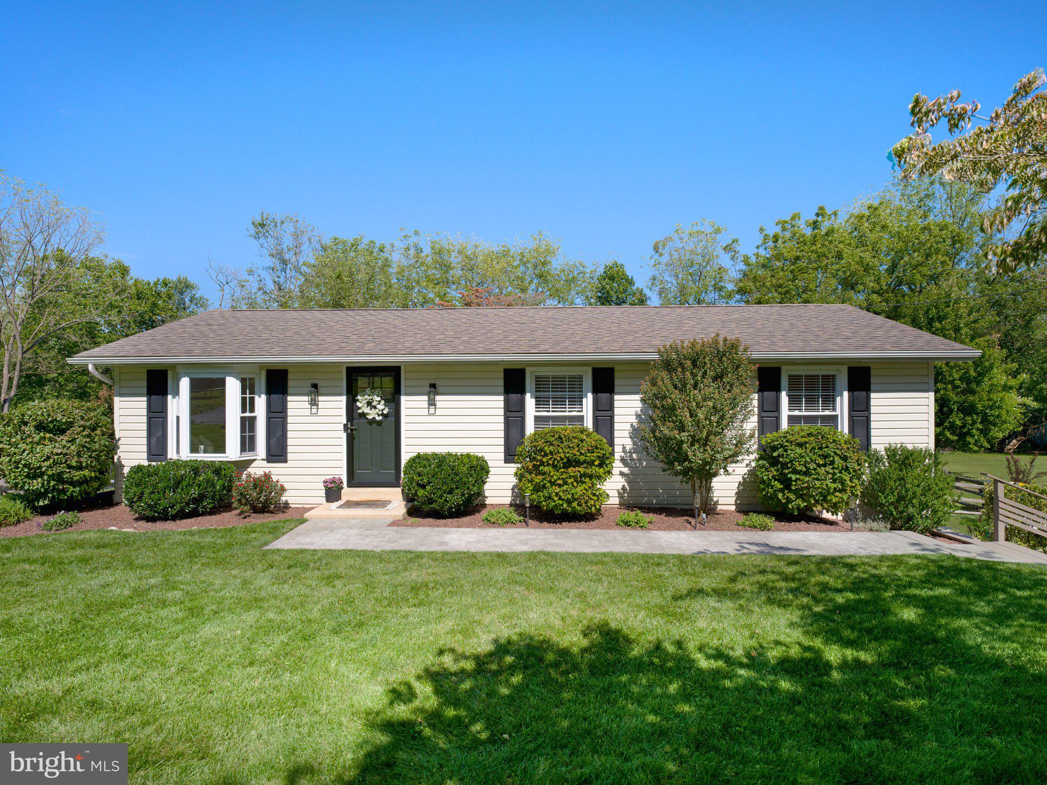 Beautifully updated neutral interiors, meticulous upkeep, and a backyard designed to be enjoyed—welcome to 1309 Marshallton Thorndale Road. This charming three-bedroom ranch in West Bradford Township makes the most of its thoughtfully arranged spaces, surrounded by lush lawns, mature trees, and carefully tended landscaping.A large bay window fills the living room with natural light, while warm wood flooring and recessed lighting create an inviting atmosphere. The refreshed kitchen features light cabinetry, granite countertops, a subway tile backsplash, stainless steel appliances, and under-cabinet lighting. With ample cabinet space and an adjoining dining area, it’s a welcoming place to prepare meals and gather around the table. The dining area opens directly to the deck, creating an easy flow for indoor and outdoor entertaining.Three bedrooms provide restful retreats and flexibility for a home office or guest room. The beautifully updated bathroom pairs a natural wood double vanity with stylish mirrors and fixtures for a fresh, timeless feel.The outdoor spaces are a standout. An expansive deck offers room for summer dinners and leisurely afternoons, with a pergola and retractable awning providing shade. Beyond the deck, the spacious backyard is framed by split-rail fencing, colorful plantings, and mature trees. Gather around the fire pit on cool evenings, enjoy a quiet morning coffee, or savor the rewards of growing your own seasonal harvest. Paver walkways connect the outdoor spaces, and a storage shed keeps gardening essentials close at hand.Downstairs, a bright, refreshed laundry area features a utility sink and shelving, with a substantial crawl space providing additional storage. The attached two-car garage offers covered parking, cabinetry, and a workspace. Carefully maintained and full of inviting details, this home is ready for its next chapter!