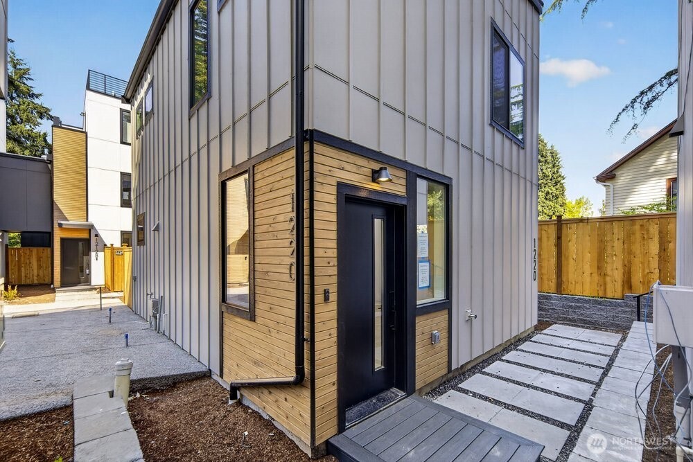 Welcome home to modern living in Seattle’s Maple Leaf neighborhood! This brand-new detached home offers a bright, open layout with thoughtful design and stylish finishes throughout. Step inside to an expansive main-level living, dining and kitchen space filled with natural light. The sleek kitchen features quartz countertops, a large island with seating and storage, stainless steel appliances, contemporary cabinetry and warm tile accents. Sliding doors extend the living space outdoors to a private patio, perfect for morning coffee, summer dinners or simply enjoying a little fresh air. A convenient powder room completes the main level. Upstairs, you’ll find two comfortable bedrooms, including a primary bedroom with ensuite 3/4 bath, plus an additional full bath. Engineered hardwood floors, ductless heating and cooling, abundant recessed lighting and thoughtful storage add to the home’s clean, functional design. Tucked away from the street for added privacy while still conveniently located near Northgate, neighborhood shops, dining, parks, transit and easy commuter routes.