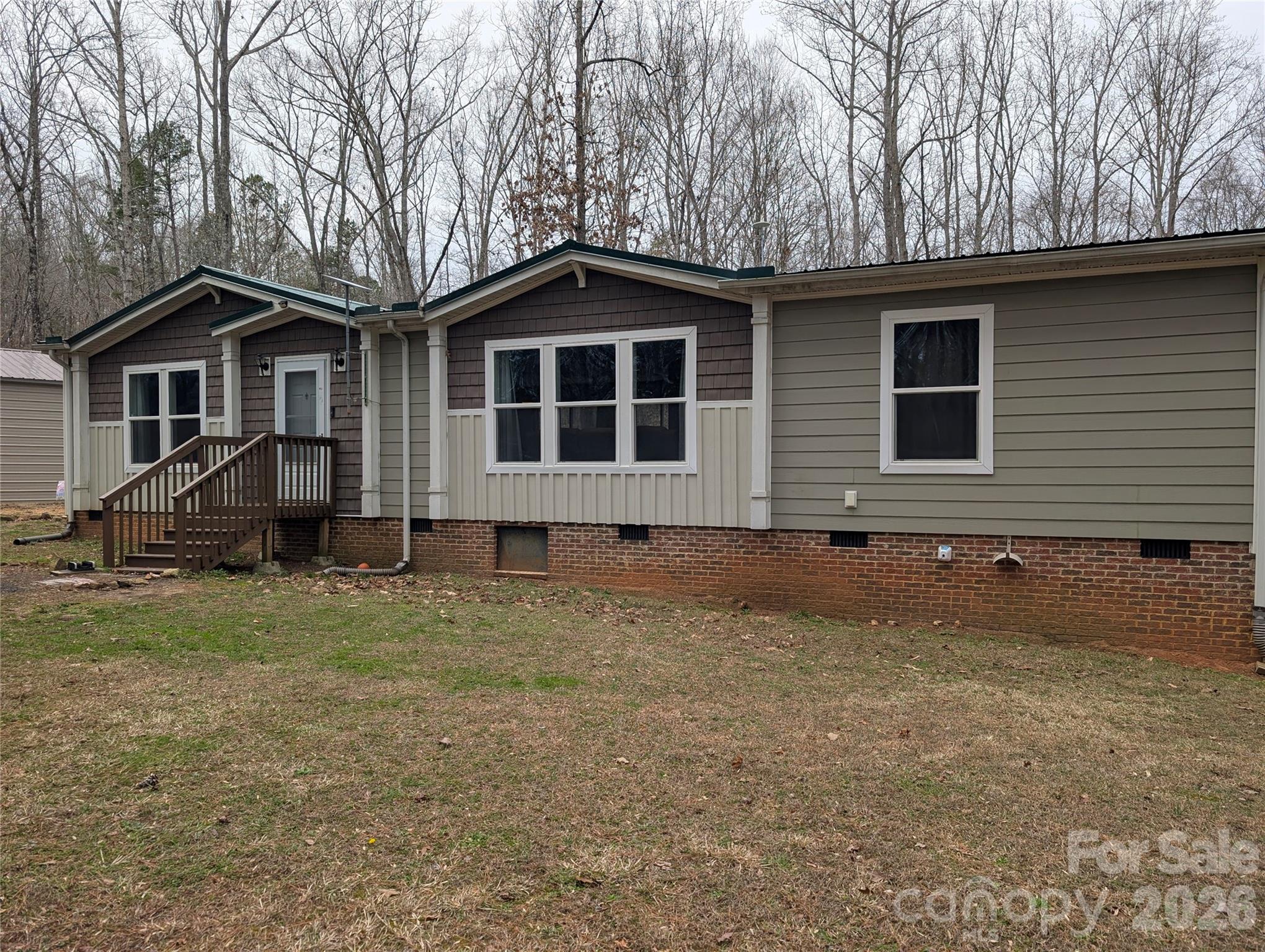 Craving space, privacy, and freedom from HOA restrictions? Welcome to your private retreat on 14 serene acres surrounded by mature hardwoods. Built in 2017, this charming 3-bedroom, 2-bath home offers a thoughtfully designed split floor plan with inviting, comfortable living spaces throughout. A recently added 30x30 detached garage/shop is wired and ready for your hobby or small business needs. Within the last two years, this home has received all new HVAC, flooring, kitchen appliances, paved driveway, and structural improvements. The heart of the home is a spacious eat-in kitchen featuring a center island, pantry with a stylish sliding barn door, and plenty of room to gather. An oversized laundry and craft room adds extra flexibility for hobbies, storage, or workspace needs. The owner’s suite is a true escape—bright and airy with soft neutral tones, a spa-inspired bathroom complete with an oversized tiled shower, and a separate soaking tub perfect for unwinding. Step outside and take in the peaceful surroundings from the large deck with included patio set—ideal for relaxing or entertaining while overlooking your own private sanctuary. A durable raised-seam metal roof was installed in 2022 for added peace of mind.