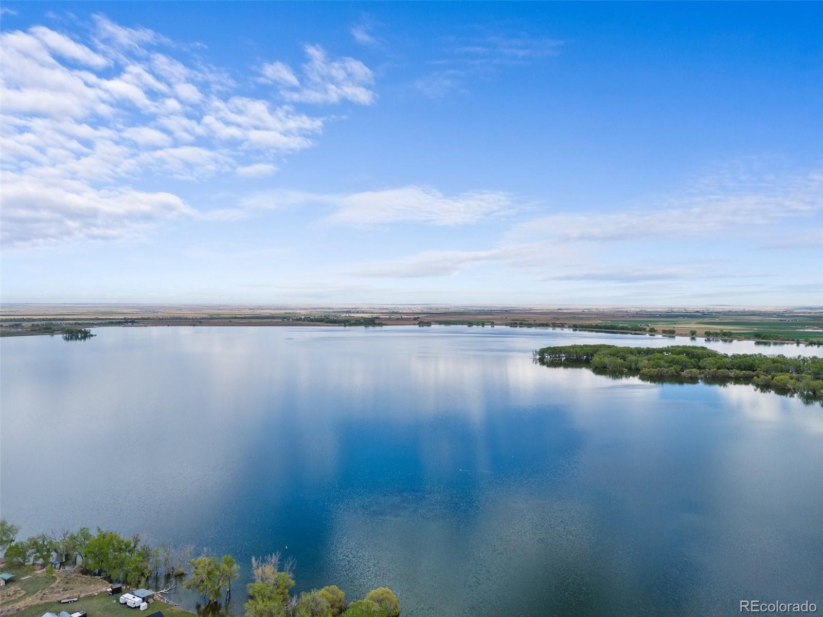 Introducing a once-in-a-lifetime opportunity in eastern Colorado.

Discover the allure of this 320-acre trophy property, a hidden gem nestled along the serene shoreline of the exclusive Empire Reservoir. Boasting a private boating club with over 30 years of unwavering member loyalty, this property presents an exceptional business prospect for discerning investors. Included with the purchase are access to 42 guaranteed boat permits, granting privileged access to the expansive, private reservoir – surpassing even the dimensions of the renowned Chatfield Reservoir.

Conveniently located within an hour's drive from the vibrant city of Denver, a mere 45 minutes from the Denver International Airport, and just 15 minutes from the prestigious Rodeo Dunes luxury golf course, this property effortlessly fulfills all your outdoor adventure and recreational desires. Whether you seek tranquil boating escapades, invigorating water sports, or simply basking in the breathtaking natural surroundings, this unique property promises an unparalleled lifestyle experience.

Seize the opportunity to own a piece of paradise, where the allure of exclusive waterfront living harmonizes with the convenience of urban amenities. Embrace the potential for a thriving boating club business while indulging in the countless possibilities for outdoor enjoyment. Don't miss your chance to make this extraordinary property your own and embark on a lifestyle defined by luxury, adventure, and natural splendor.

If the whole 320 acre property is too large for your needs, the sellers are also open to selling one or two of the eight parcels separately. The two 40-acre parcels available are currently listed online MLS#'s 5081932 & 3331463. Please reach out for more information, questions or to schedule a tour.