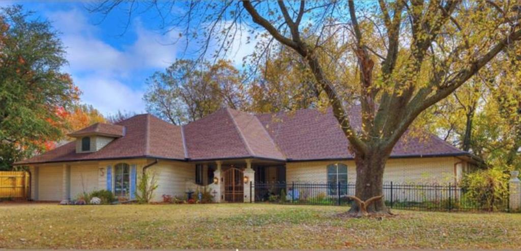 Nestled on a charming, tree-lined street in one of Norman’s best neighborhoods, this gem offers charm and comfort less than a mile from the OU campus and downtown Norman. It has 4 spacious bedrooms (one can be used as office space, with an independent entrance), 2 1/2 baths, two spacious living areas, an updated kitchen and an oversized fireplace. It features unique wooden screen panels and custom built-in cabinetry thoughtfully integrated to a cohesive interior design. Seamless pocket doors increase flexible overall spatial use. An enhanced lot with a creek in the back, a charming private front courtyard, a sun-filled side yard, and a wooded backyard with scenic views offer several great outdoor spaces to retreat and unwind.