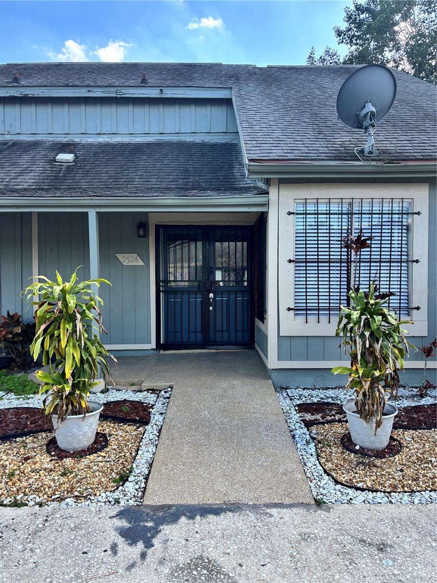 Come see this fully remodeled 3 bedroom, 2 bathroom home with LPV floors throughout. The front double door entrance is beautifully designed with stained glass windows. A spacious laundry room,  modern fresh paint and updated light fixtures set the tone for this home. On the first floor there is one bedroom, bathroom, living room/ dining room combo and updated kitchen with stainless steel appliances. The kitchen cabinets pop with color and the new sliding doors invite you to cook on the outdoor brick grill. This backyard is perfect for entertaining. You have extra storage with a closet under the stairs and a big enough yard for a shed. Upstairs you have a second bedroom, bathroom and the Owner's Suite with double entry doors and a spacious oversized closet. Best part of all is you are only a short drive from Disney and minutes away from I-4. Call now to schedule your appointment to see this affordable home. Priced to Sell, it won't last.