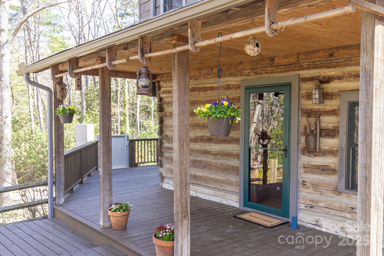 A true paradise for horse and nature lovers! This serene 9.14-acre property offers privacy, peace, and endless possibilities. Perfect for horses, livestock, farming, gardening, a flower farm—or simply a private retreat. The cozy living room, originally an 1800s chestnut oak cabin, features a woodstove and combines rustic charm with modern comfort. It opens into a spacious eat-in kitchen, ideal for gatherings. A bright and inviting sunroom overlooks wildflower gardens and a soothing waterfall. Upstairs, you’ll find a full bath, a primary bedroom, and three additional bedrooms. Unique architectural touches include recycled Douglas fir beams. Radiant floor heat in the downstairs bathroom and laundry room. Enjoy outdoor living on the expansive front porch and wrap-around deck, or relax in the fully fenced yard—perfect for pets. A registered Monarch Waystation and part of the Butterfly Highway, this home is a haven for pollinators and nature watchers alike. Just 20 minutes from Asheville and close to local breweries, hiking trails, and more.