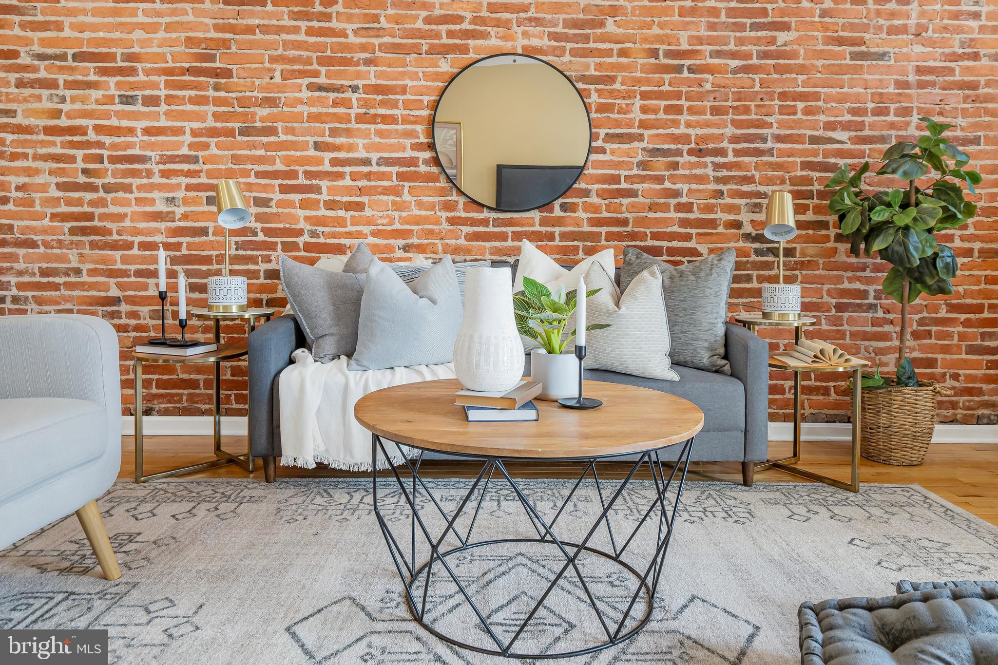 Nestled in the heart of Canton, this expansive and breathtaking end-of-group row house is a true gem, offering a wealth of amenities and an abundance of natural light. With approximately 1,850 square feet of living space, this home boasts three bedrooms and three-and-a-half bathrooms, providing ample room for comfortable living.Upon entering the main floor, you'll be greeted by a primary bedroom complete with an en-suite bathroom, creating an oasis of relaxation and convenience. The main level also features an abundance of charm, highlighted by exposed brick walls that lend character to the space. Elegant details such as recessed lighting, crown molding, and chair rail further enhance the ambiance. The kitchen is a chef's dream, equipped with stainless steel appliances and granite countertops, offering both style and functionality. A beautifully tiled bath adds a touch of luxury to everyday living. The open chair staircase and decorative fireplace add to the overall allure of this residence.As you ascend to the upper level, you'll discover two additional bedrooms, each showcasing exposed brick walls and a vaulted ceiling that creates an inviting and airy atmosphere. Tiled baths on this level maintain the home's commitment to quality and style. The real treasure awaits on the rooftop deck, where you can unwind and enjoy picturesque views of the surrounding area.Conveniently located just 160 steps away from Canton Square, this property invites you to explore a vibrant neighborhood known for its bar hopping opportunities and fine dining experiences. For those who appreciate waterfront living, the Canton waterfront is a mere three blocks away, offering serene moments by the water's edge. Commuters will appreciate the home's proximity to major transportation arteries, including I-95 and I-895. Additionally, the esteemed Johns Hopkins University is just a short drive away, making this location ideal for professionals and students alike. Don't miss the chance to make this remarkable Canton residence your own.