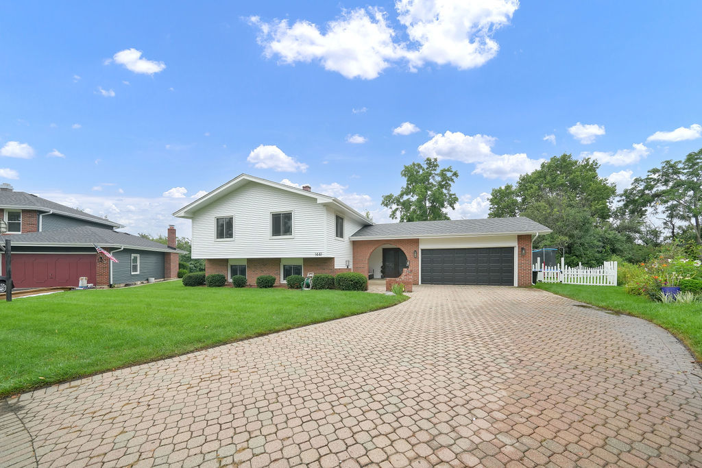 WELCOME HOME! The feeling of home is immediate the moment you step into this spacious and beautifully updated tri-level property. The welcoming foyer/mudroom features wood laminate flooring and offers a great view of the backyard patio. The second level boasts a bright, open-concept layout with a spacious living room, dining room, and updated kitchen. The kitchen was remodeled approximately four years ago and features soft-close cabinetry, a large center island, quartz countertops, and stainless-steel appliances. Natural sunlight fills this inviting space, creating the perfect setting for everyday living and entertaining. This level also offers three spacious bedrooms, including a primary suite with its own private bathroom. All bedrooms provide ample closet space. The bathrooms have been tastefully updated with stylish modern ceramic finishes and contemporary vanities. The lower level offers even more living space, including a large family room with new flooring, trim, and recessed lighting. A gas fireplace with double glass doors creates a warm and inviting atmosphere, while access to a second patio provides additional outdoor living space. This level also includes the fourth bedroom, a dedicated office, and a separate laundry room. The home has been extensively updated within the past four years, including all windows, flooring and carpeting, roof, gutters, and fascia. The entire home has also been professionally painted. Move-in ready and filled with thoughtful updates, this home offers the space, style, and comfort you've been looking for. You truly must see it in person to appreciate everything it has to offer!