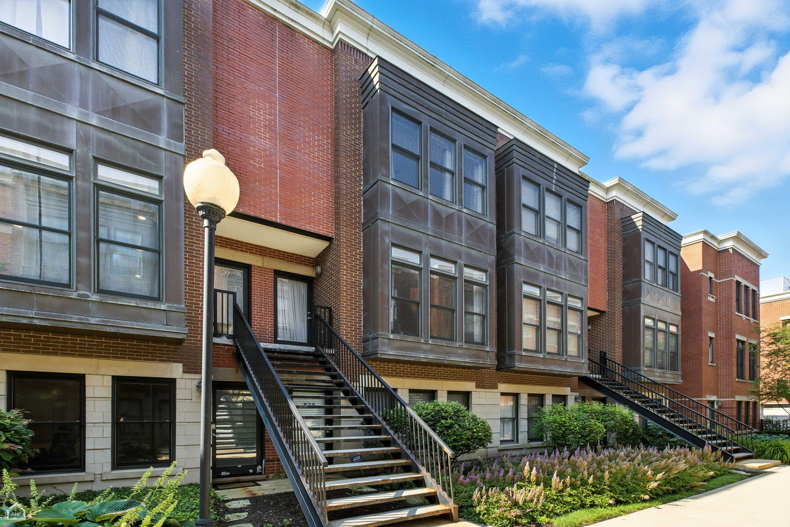 Situated in a charming courtyard garden in the heart of University Village, this bright sun-filled 3-bedroom, 2.5 -bath Townhome features living/dining open floorplan and boasts an attached 2-car garage for convenience. NEW, massive deck updated in June 2024 w/ Southern exposure off the kitchen-- perfect for outdoor living and BBQ. With its fresh paint, the patio railing now exhibits a chic and polished look. 10 ft. ceilings w/hardwood floors & crown molding in the main living space. Bright kitchen w/42" cabinets, pantry, SS appliances. Massive, private rooftop w/ spectacular SKYLINE VIEWS! Spacious master bedroom w/ walk-in closet. 3rd bedroom w/ full kitchen can be closed off as a legal studio rental w/ separate entrances to garage & outside. Turn your home into an income producing investment or the perfect in-law/nanny arrangement! University Village offers numerous parks, two playgrounds, lush landscaping, pet areas, and grounds to stroll and explore. Conveniently located near the vibrant neighborhoods of Pilsen, West Loop, Greek Town, and South Loop, and just minutes from River North, the Loop and Lakefront, you'll have easy access to the expressway, CTA Blue Line, and buses. Enjoy breathtaking city skyline views from your rooftop, Don't miss this opportunity, come take a look for yourself!