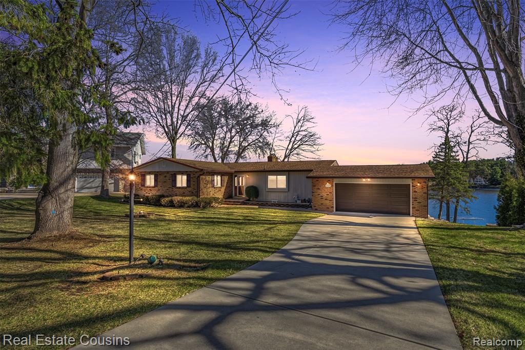 Welcome to this Lake Shannon ranch offering approximately 100 feet of lake frontage, spectacular water views from nearly every room, and beautifully landscaped grounds that slope gently to the shore. Nestled near the end of a quiet cul-de-sac, the home combines peaceful privacy, an up north feel, and easy lake access. Interior features include 4 bedrooms and 3 full baths, an open, light-filled layout and expansive windows that frame the beautiful water views. Walkout basement with full bath makes coming in off the lake convenient without tracking in water or sand to the upstairs living space. Step outside to a large two-level deck—perfect for entertaining,  or simply relaxing while watching the sunrise over the water. Lake Shannon is a private, all-sports lake located in Tyrone Township near Fenton. Enjoy the rare combination of recreational boating and tranquil, secure lakeside living. Close to both Fenton and Hartland for the perfect mix of shopping and restaurants. A great opportunity for lake lovers seeking exceptional views, outdoor living, and a serene neighborhood setting.