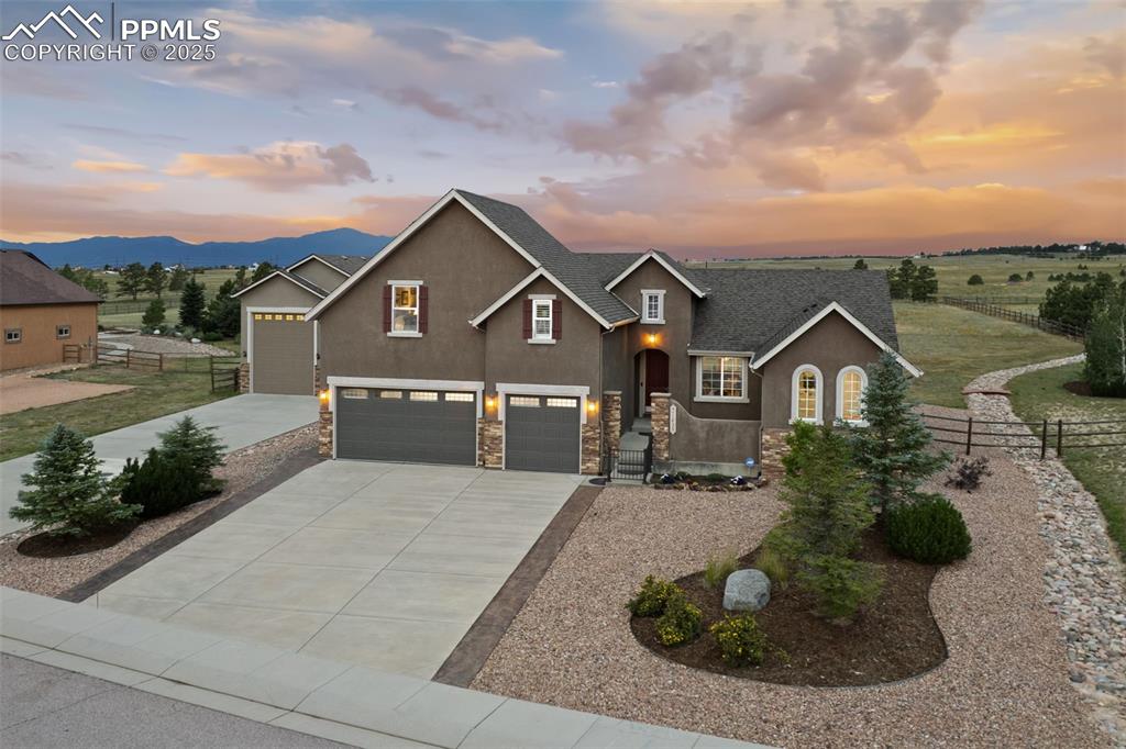 Lovingly lived in and cared for custom home with Pikes Peak views and plenty of elbow room...This Meridian Ranch Estates property is a one owner home and it shows! Modern floor plan that offers cozy private corners and tremendous entertaining ability on top of incredible outdoor living spaces including a lovely courtyard patio in front and an expansive deck in back. The kitchen is a cook or entertainer's dream complete with granite countertops, stainless steel appliances, wine/beverage fridge, gorgeous cabinetry with room for everything, coffee bar, pantry with pull out drawers, HUGE island, formal dining room and breakfast nook on top of full access to the rear deck and incredible backyard! Timeless finishes throughout...the primary bedroom is on the main level and boasts a walk out to the deck as well as a 5 piece bath and large walk in closet. Full main level living is a breeze with a large laundry room along with an additional bedroom and full bathroom. The upper level could be an additional large primary suite, guest quarters, studio, theater room, office or gym area. The lowest level of this property is another wide open family room complete with wet bar, plenty of storage as well as another comfortable bedroom and full bath.  This gem of a home is in and of itself fabulous...but wait, there's more!  The detached garage/shop/ and RV storage with a loft is a dream come true for any hobbyist of any kind. A truly spectacular home in an area bustling with shops, restaurants, golfing and more all while offering a real piece of Colorado living.  We look forward to welcoming you home!