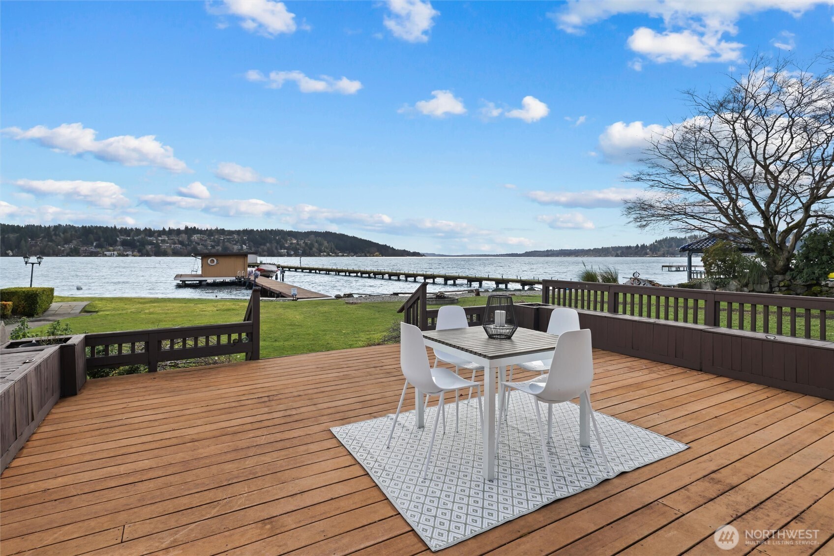 Set on a beautiful, level 13,756 square foot parcel with 43 feet of prime no-bank frontage, this 2 bedroom, 2 bath bungalow offers an exceptional opportunity to enjoy life on the water in the heart of Lake Forest Park’s highly sought-after Sheridan Beach neighborhood. The 1,590 square foot, one-and-a-half story home, originally built in 1929, has been thoughtfully updated over the years and features a recently renovated kitchen and bathrooms that blend modern tastes with the home’s timeless character. Gleaming hardwood floors & light-filled living spaces opens to a generous waterside entertaining deck—perfect for taking in the ever-changing lake views and spectacular sunrises. A level lawn stretches to the water’s edge and the 110-foot shared dock, complete with boathouse with boatlift & 2 jet-ski lifts, providing easy access to the lake for boating, swimming, and waterfront recreation. Two-car garage and additional off-street parking add everyday convenience. Perfectly located on a quiet residential lane, the home is within walking distance to Lake Forest Park Town Center, the Lake Forest Park Civic Club, and the Burke-Gilman Trail, and just 10–15 minutes to University Village, Magnuson Park, and the broader amenities of Seattle. An exceptional opportunity to own a beautifully sited Lake Washington waterfront home with spectacular views & timeless character in a truly special setting.