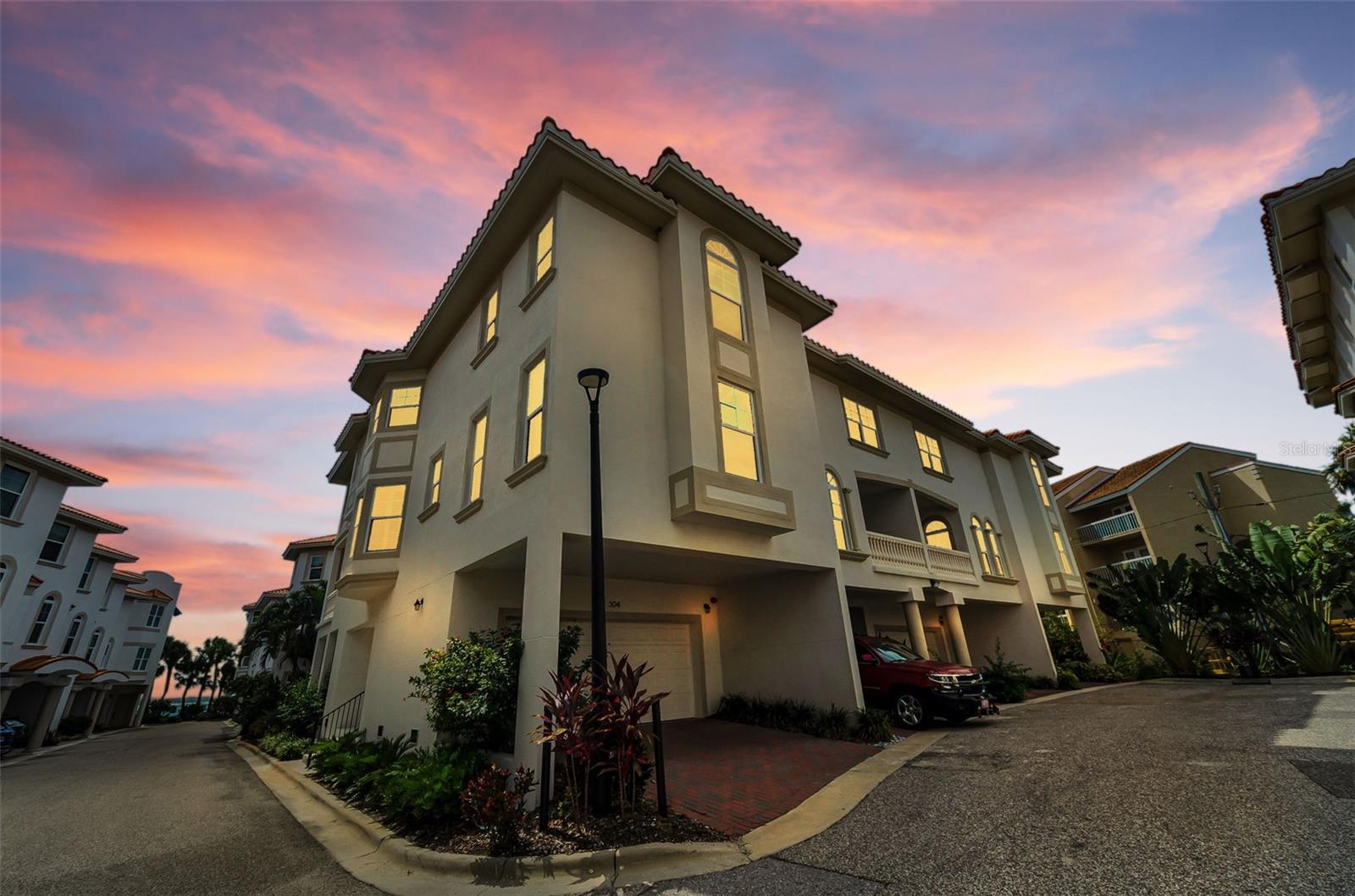 2023-BUILT HOME in LIKE-NEW CONDITION without new construction prices! Welcome to San Ruffino, one of Dunedin's premier gated waterfront communities, where luxury and the Florida lifestyle come together. END UNIT with only one owner, this BEAUTIFULLY MAINTAINED THREE-STORY condominium lives like a TOWNHOME and offers 3 bedrooms, 3 full bathrooms, and TRANQUIL WATER VIEWS of ST JOSEPH SOUND and the INTRACOASTAL WATERWAY. Constructed with solid BLOCK construction and BUILT TO MIAMI-DADE HURRICANE STANDARDS, this exceptional residence combines quality craftsmanship with elegant coastal design. Designed with both elegance and functionality in mind, the impressive chef's kitchen features premium stainless steel FULGOR MILANO appliances, including a convection oven, quartz countertops, a stunning coastal-inspired tile backsplash, soft-close cabinetry, abundant storage, and a touch-activated kitchen faucet. The open-concept second floor also features a spacious dining area, inviting living room, corner balcony with beautiful WATER VIEWS, a guest bedroom, and a full bathroom with a walk-in shower. Thoughtful architectural details include soaring 10-FOOT CEILINGS, impressive 8-foot interior doors, 5¼-inch baseboards, ENGINEERED WOOD FLOORING throughout the main living areas, and wide staircases that enhance the home's spacious feel. A PRIVATE ELEVATOR provides effortless access to every floor, while HURRICANE IMPACT WINDOWS and DOORS provide added peace of mind. Plantation shutters and Hunter Douglas top-down blinds provide style and privacy throughout. The luxurious THIRD-FLOOR PRIMARY SUITE serves as a private retreat, featuring its own CORNER BALCONY OVERLOOKING ST JOSEPH SOUND, a generously sized walk-in closet with a custom organization system. The spa-inspired ENSUITE BATHROOM offers quartz countertops, an oversized walk-in shower, and a freestanding soaking tub. An additional bedroom on the third floor and a LAUNDRY ROOM with a utility sink add everyday functionality. The first floor features an oversized TWO-CAR GARAGE with generous storage for vehicles, bikes, and beach gear, along with a LARGE PATIO perfect for relaxing or entertaining. San Ruffino offers an exceptional WATERFRONT LIFESTYLE with a GATED ENTRANCE, landscaped grounds, guest parking, a resort-style community POOL overlooking St Joseph Sound and the Intracoastal Waterway, a FISHING PIER, kayak launch, and private waterfront seating areas perfect for watching dolphins, boats, and spectacular sunsets. This PET-FRIENDLY condominium association provides MAINTENANCE-FREE living with roof maintenance, water, sewer, trash, and exterior grounds maintenance included. Outdoor enthusiasts will appreciate direct access to the PINELLAS TRAIL just across from the community via Wilson Street Park, connecting to over 45 miles of scenic biking, walking, and running trails. Located just one mile from vibrant DOWNTOWN DUNEDIN, you'll enjoy award-winning restaurants, charming boutiques, breweries, waterfront parks, farmers markets, festivals, and a golf cart-friendly lifestyle. The property is also located within the highly regarded Pinellas County School District. Ideally situated only 6 miles from Honeymoon Island State Park, 7 miles from Clearwater Beach, and approximately 22 miles from Tampa International Airport, this exceptional residence offers the perfect blend of luxury, location, and the relaxed Florida waterfront lifestyle.