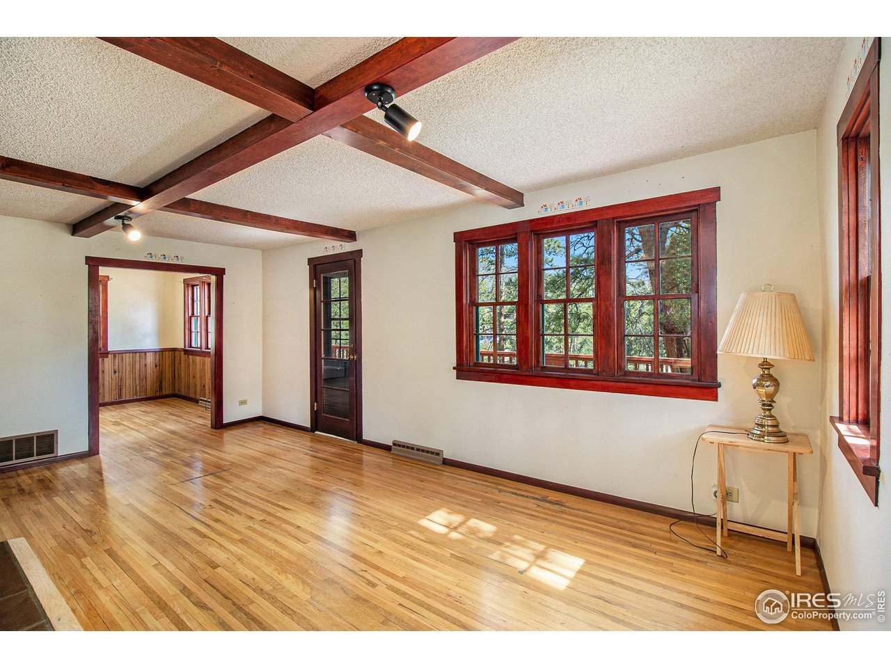 This unique property features an existing residence set on a large, private lot along a private drive, offering a rare combination of seclusion and versatility. The home blends historic charm with thoughtful modern updates and features a spacious open floor plan well suited for comfortable main-level living. Highlights include a wraparound deck, fenced yard, attached garage, and an additional detached garage.Conveniently located just minutes from downtown and a short drive to Rocky Mountain National Park, this property presents an exceptional opportunity for those seeking privacy, flexibility, and a prime Estes Park location. Features existing residence plus two separate, buildable lots on a private drive. Home is on 0.65 acres, Lot 2 0.48 acres, Lot 5 0.28 acres. Keep land or sale off 2 lots to pay for the purchase.
