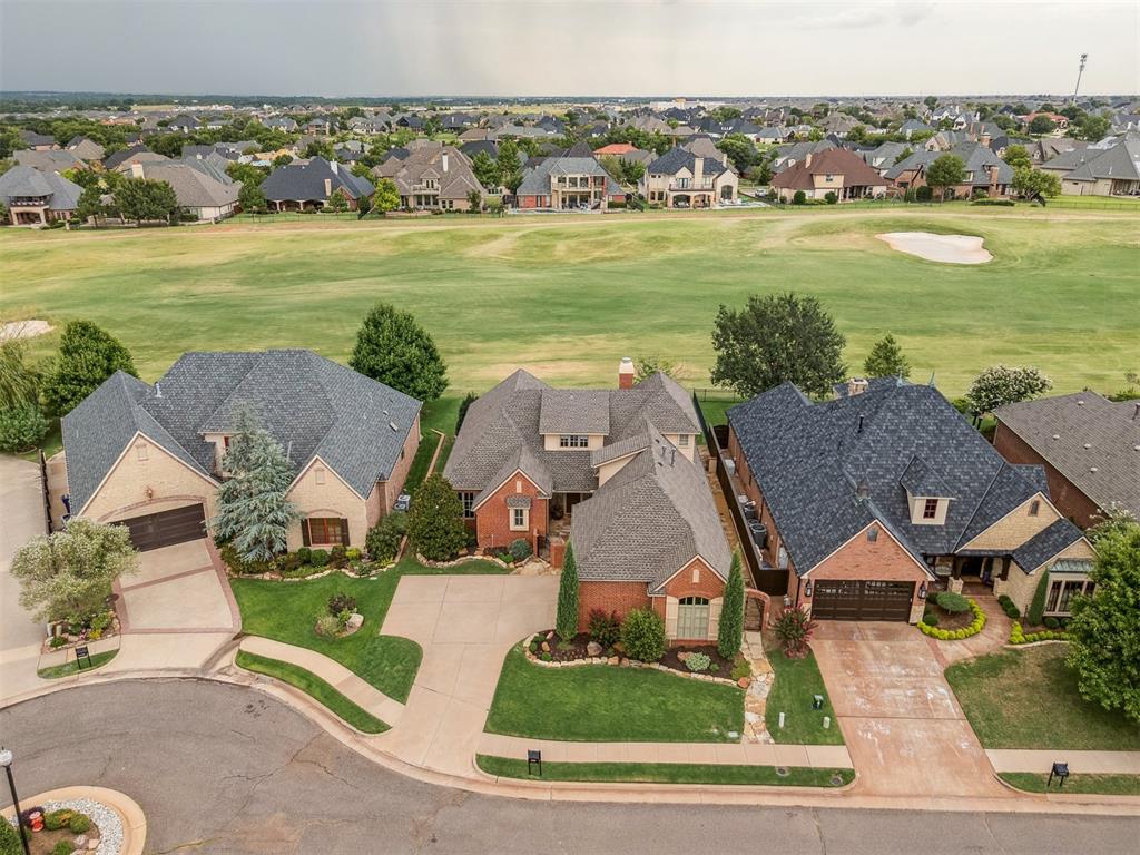 Welcome to this beautifully maintained golf course home nestled in the prestigious, gated Rose Creek neighborhood, offering breathtaking views of the 8th fairway. This versatile floor plan features 3 spacious bedrooms plus a bonus room, or can easily function as 2 bedrooms + a dedicated office and bonus room, perfect for remote work or guests. Inside, you'll find rich stained concrete floors and thoughtfully defined living spaces that offer both comfort and functionality. The spacious living room is a true focal point, featuring stunning wood-beamed ceilings that add warmth and character, along with large windows that frame serene views of the fairway. The kitchen and dining areas are set apart yet easily accessible, allowing for privacy while still maintaining a natural flow for daily living and entertaining. The primary suite overlooks the golf course and includes a spa-like ensuite bath and a generous walk-in closet. Enjoy peaceful mornings and vibrant sunsets from your private backyard retreat, perfectly positioned along the lush greens. The primary suite offers a spa-like bath and generous walk-in closet, while the flexible bonus room provides extra space for a media room, gym, or playroom. Rose Creek offers 24/7 security, a community pool, fitness center, clubhouse, and easy access to top-rated schools, shopping, and dining. Don't miss your chance to own this one-of-a-kind home in one of Edmond’s most desirable golf communities!