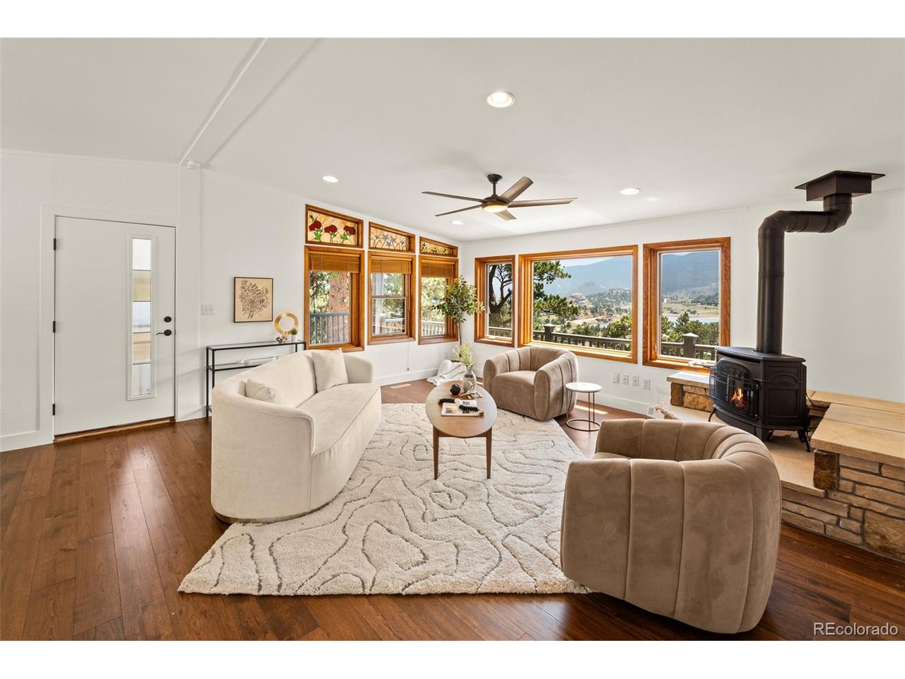 Wake up to sweeping mountain views over Mary's Lake every morning. Perched at the top of Little Prospect Rd and backing to 40 protected acres of land trust, this mountain retreat delivers privacy & panoramic views that don't come around often. Main-level living puts everything you need on one floor - a vaulted great room anchored by a gas stove and stone hearth, oversized picture windows framing the mountains, and original stained-glass window accents that add real character. The primary suite is also on the main level, with a spa-like updated bath. This home has been remodeled top to bottom: new flooring, updated bathrooms & bedrooms, refreshed lighting, painted kitchen cabinets, refinished granite counters and updated appliances. Downstairs, the finished walk-out lower level has its own separate entrance and a full second living space - family room, home office nook, kitchenette, 2 bedrooms & a full bath - ideal for guests, multigenerational living, or rental income. An upgraded solar system with battery backup keeps the home running through any outage.  Outside of the home, a unique 720 sf detached bonus building offers endless flexibility as an art studio, gym, game room, or whatever your heart has been looking for! A fenced yard adds even more usability to this half-acre lot. Hot tub, composite deck and so much more to explore on this incredible property. This 5 bed, 3 bath is minutes to Rocky Mountain National Park and all Estes Park has to offer, but tucked away in total privacy. Schedule your private showing today!
