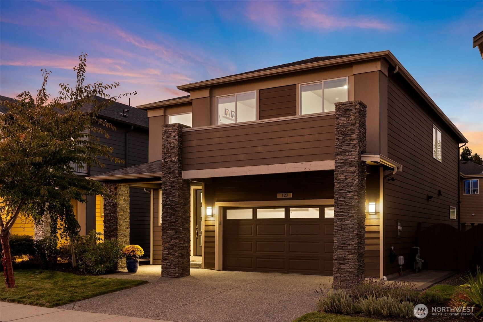 Built in 2018, this contemporary Ryan Park home welcomes you with radiant natural light and rich espresso-toned hardwoods that sweep across the open main floor. A sleek kitchen with quartz countertops, full-height tile backsplash, and pantry flows effortlessly into the dining area and fenced backyard—an inviting setting for al fresco entertaining. The living room’s stacked-stone fireplace forms a warm centerpiece, while upstairs, a spacious bonus room and tranquil primary suite offer everyday retreat. With over $65K in upgrades, the home showcases expanded hardwoods, backyard hardscaping, and an upgraded garage with epoxy floors and custom storage. Just steps from a community park and within the sought-after Northshore School District.