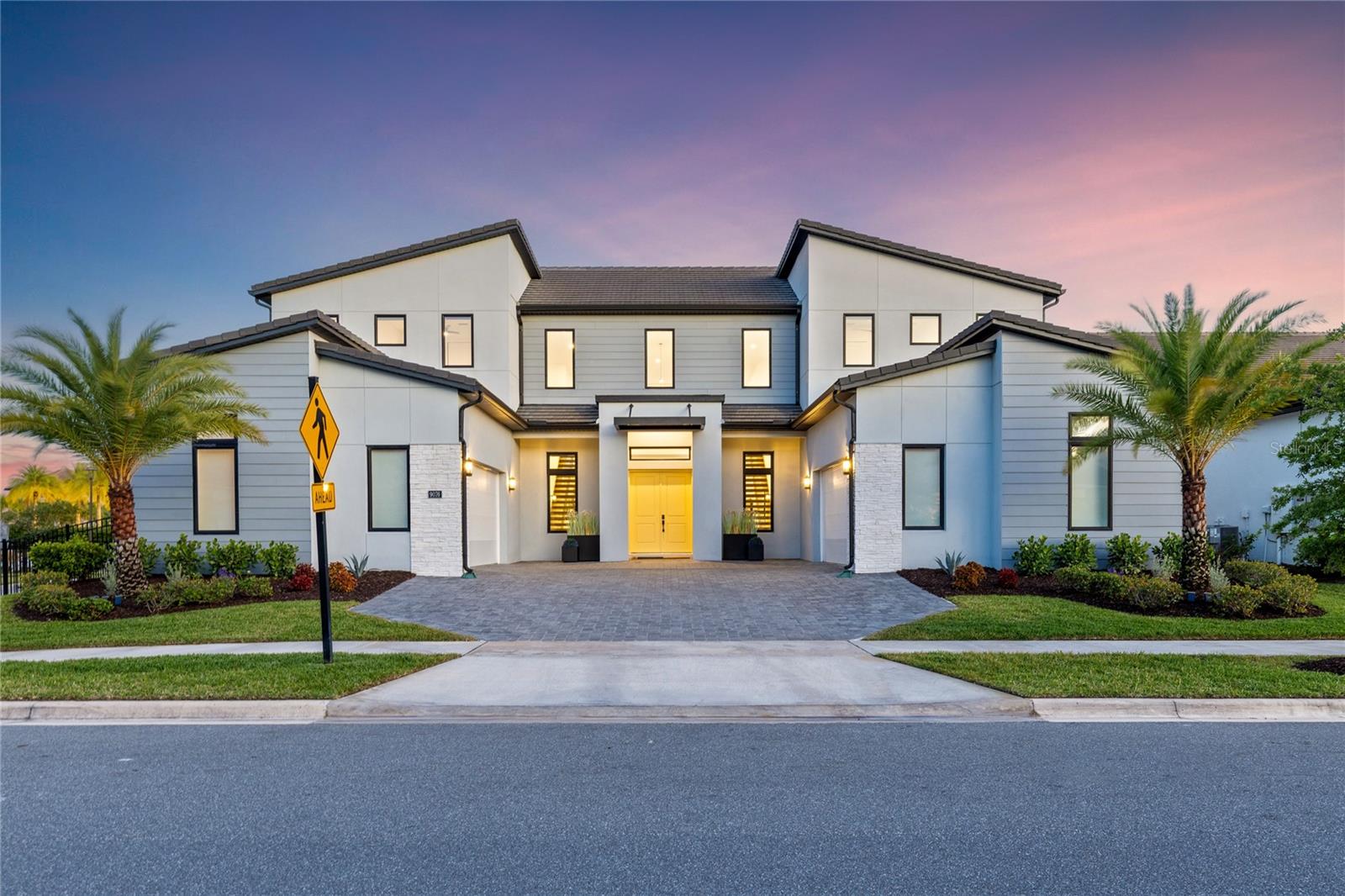 One or more photo(s) has been virtually staged. Soaring 24-foot ceilings, dual floating staircases, and a 57-foot private lap pool—this is not your typical Lake Nona home.Experience the perfect blend of luxury, functionality, and family living in this exceptional Toll Brothers residence, ideally positioned on a premium corner lot within the gated Laurel Pointe community in Lake Nona, with convenient access to Luminary Elementary and Middle School.From the moment you enter, the home makes a lasting impression. The 24-foot ceilings and dual custom floating staircases create a dramatic architectural focal point, while expansive dual-pane windows fill the space with natural light and enhance energy efficiency and comfort. Thoughtfully designed for both everyday living and entertaining, the open-concept layout offers a seamless flow between the main living, dining, and kitchen areas.At the heart of the home, the chef’s kitchen blends performance with design, featuring a 48” Sub-Zero Pro glass-door refrigerator, expansive 10-foot island, custom tile backsplash, built-in wine and beverage refrigeration, and designer alabaster pendant lighting. An oversized walk-in pantry provides exceptional storage while maintaining a clean, functional layout.Built for long-term quality, the home offers concrete construction on both levels with gypcrete between floors, delivering enhanced durability and sound insulation. Additional features include whisper-quiet Koa wood ceiling fans, app-controlled pool systems, and Cat-6 hardwired connectivity for modern convenience.Step outside to a private, resort-style retreat centered around a custom 57-foot saltwater lap pool with heating and cooling capabilities. Marble decking, a pergola with integrated ceiling fans, swim-out benches, and a full two-story screened enclosure create an outdoor space designed for both relaxation and entertaining, with a gas line already in place for a future summer kitchen and perimeter hedging for added privacy.The primary suite offers a true retreat with dual walk-in closets and a spa-inspired bath featuring an extended walk-in shower with drying area and a soaking tub. Additional upgrades include luxury vinyl plank flooring throughout, motorized window shades, floor-to-ceiling tiled bathrooms, a whole-house 7-stage water filtration system, and dual tankless water heaters.Two separate insulated 2-car garages provide a full 4-car capacity, including one fully climate-controlled and humidity-regulated with 240V power, ideal for EV charging, a home gym, workspace, or premium vehicle storage.Located within a gated Toll Brothers enclave of just 124 homes, in the heart of Lake Nona’s innovation district, this home offers convenient access to Medical City, the VA Hospital, Nemours, Town Center, and top-rated schools. Just 15 minutes from Orlando International Airport and the USTA National Campus, with easy access to major highways, theme parks, and Florida’s renowned beaches. The area continues to grow with the upcoming AdventHealth hospital and the Lake Nona West development, along with additional conveniences such as Sprouts Farmers Market—delivering a rare combination of elevated design, connectivity, and long-term lifestyle value in one of Central Florida’s most desirable communities.