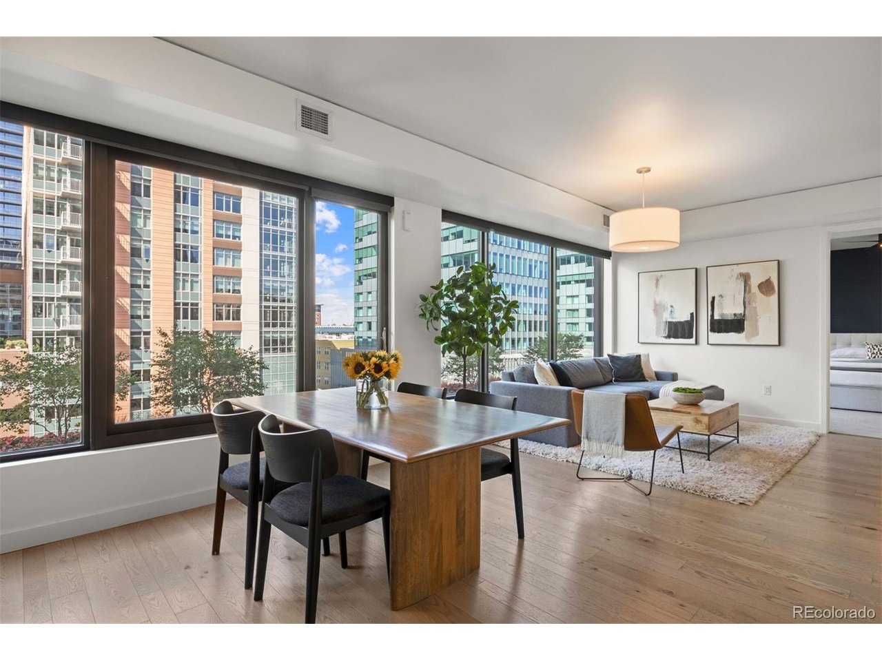 What if city living could still give you a connection to nature? Priced at $560,000, this offers an exceptional opportunity to own at The Coloradan, with a unique perspective overlooking the building's fourth-floor terrace and its trees, greenery and flowers below. From the moment you enter, it feels bright, open and inviting, with a well-designed layout that makes the most of its one-bedroom footprint. The generous living and dining areas provide ample room to entertain, while a dedicated area creates a comfortable home office without compromising the living space. The kitchen flows naturally into the main living area, while a separate utility and laundry room with full-size washer and dryer provides valuable additional storage. A hall entry closet offers another practical storage advantage not commonly found in other units. The primary suite features an ensuite bath, generous closet space and motorized room-darkening shades. The spa-inspired bathroom includes a double vanity and shower/tub combination. The Coloradan combines modern construction with an exceptional Union Station location. Enjoy a rooftop pool and hot tub, fitness center, owners' club, library, community garden, fire pit, bike storage, guest parking, 24-hour front desk and security, plus on-site management and building engineering staff. Step outside to Whole Foods, Union Station and the A-Line to Denver International Airport, with restaurants, coffee shops, fitness studios, Commons Park, Confluence Park, Coors Field, Ball Arena, LoHi and RiNo all within easy reach. This makes an appealing opportunity to experience full-service downtown living in one of Denver's newest condominium buildings, with the convenience, amenities and walkability that make The Coloradan such a desirable place to call home.