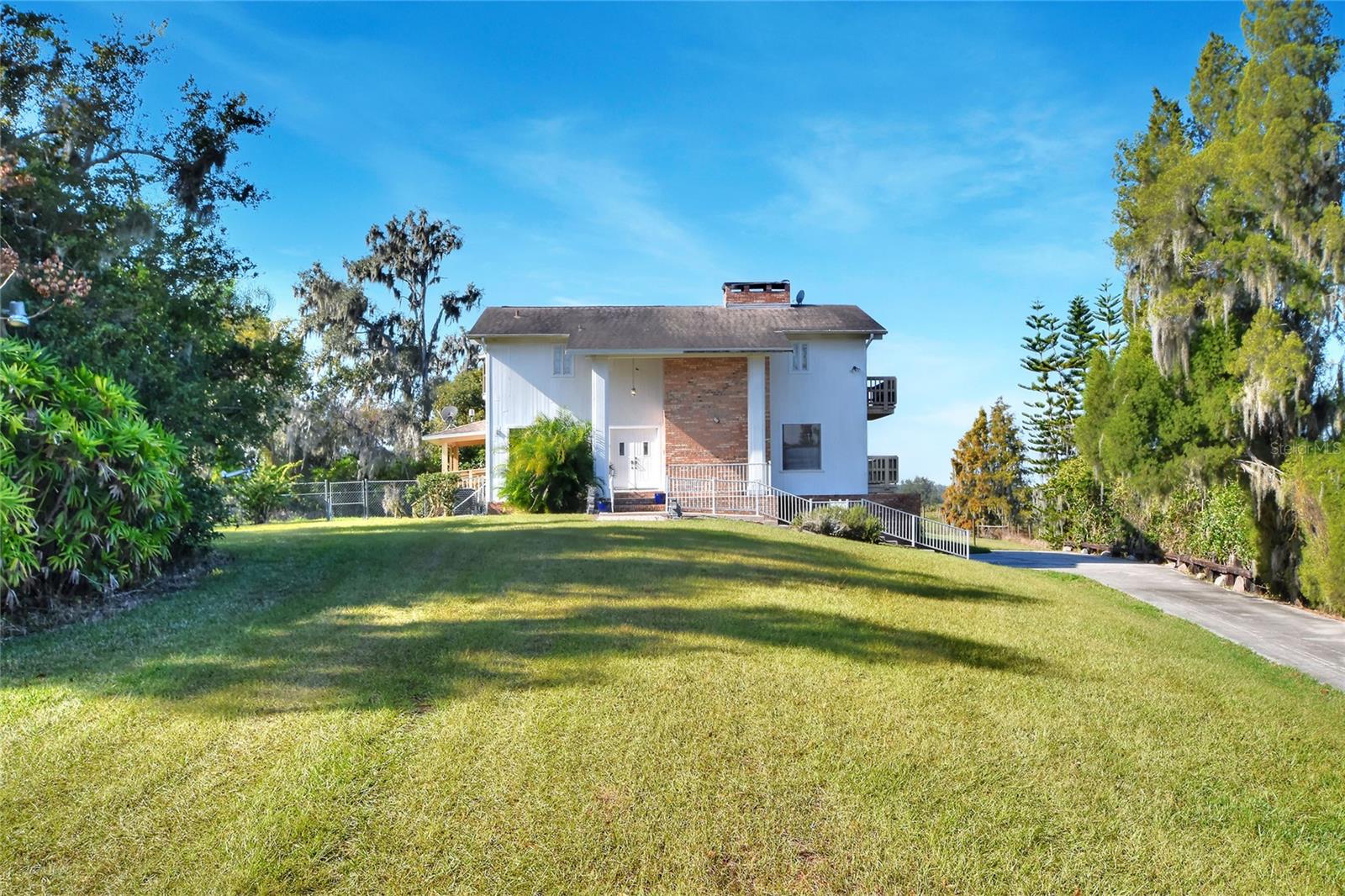 Tremendous potential awaits on this secluded 20-acre parcel located along State Road 60 between Plant City and Brandon. The 1988-built, 2,107-square-foot home features a unique three-story layout with a ground-level garage and a wood-burning fireplace. While the home is functional, it is ready for updates—offering an excellent opportunity to renovate, customize, or repurpose. The expansive acreage provides ample space for animals, equipment, and outdoor activities, all while benefiting from convenient highway access. Ideal for agricultural use, recreation, or a rural lifestyle with room to grow.