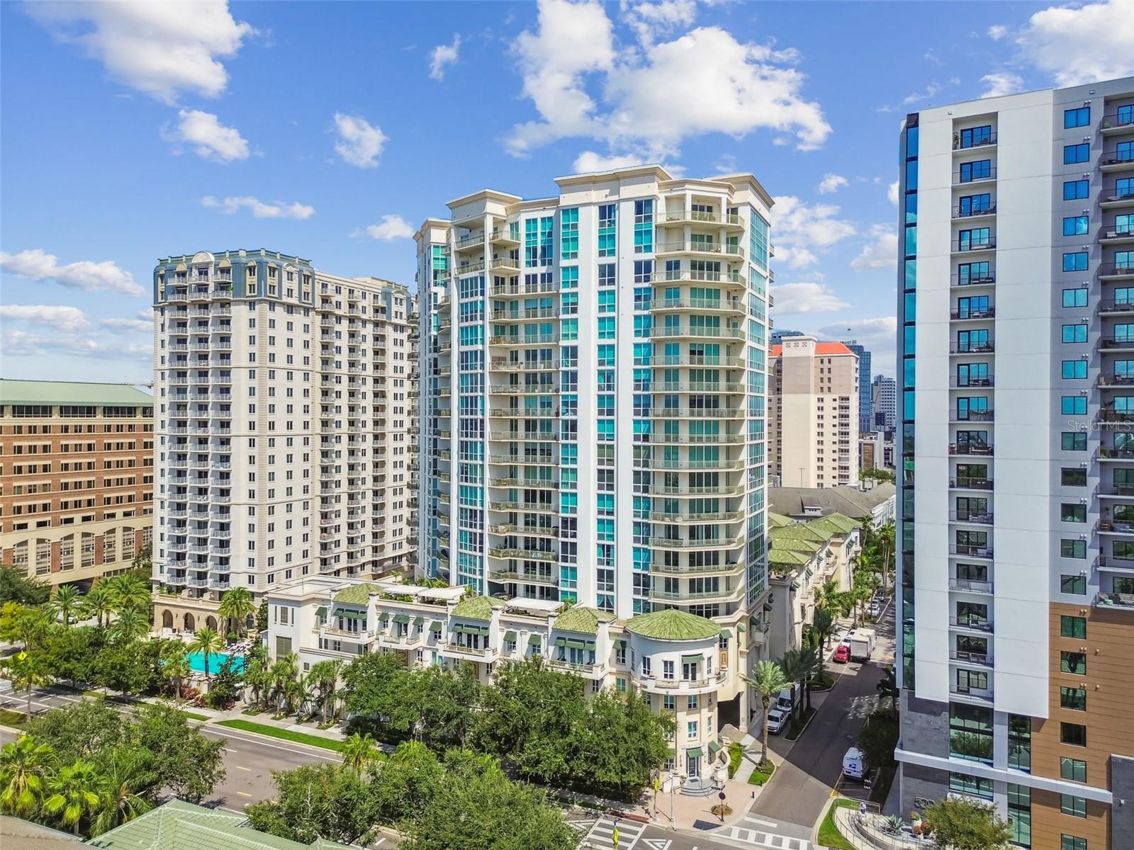 Set on the 5th floor of The Plaza on Harbour Island, this 3-bedroom, 3-bath residence offers the perfect blend of elevated city living and a connected, walkable lifestyle. From its rare expansive wraparound terrace, enjoy a unique perspective—high enough for sweeping views, yet close enough to feel part of the vibrant Harbour Island community. Inside, natural light pours through floor-to-ceiling windows, highlighting the open layout, modern finishes, and seamless indoor-outdoor flow. The kitchen, fully renovated in 2021, is both stylish and functional with custom white shaker soft-close cabinetry, marble waterfall countertops, and a matching backsplash. GE Café appliances include a 5-burner gas range with hood, microwave/convection oven with WiFi connect, second full-size oven with Wifi connect, dishwasher, wine fridge, and pot filler. A bar-style eat-in counter adds an inviting, casual touch. The primary suite offers a serene retreat with a large bedroom, a walk-in closet, and a spa-like bath featuring a dual-sink stone vanity, walk-in shower, and garden tub. The second bedroom enjoys its own floor-to-ceiling windows, custom lighting, and walk-in closet, with a hall bath nearby offering an extended stone vanity and walk-in shower. The third bedroom includes a private ensuite with a shower/tub combo and stone vanity. A dedicated laundry room with a stackable Smart washer/dryer with Wifi features and utility closet adds convenience. Additional details— one of the few units with gas, solid core doors, tray ceilings, crown molding, recessed lighting, blinds throughout, and built-in fire sprinklers—underscore the home’s quality and comfort. The oversized wraparound terrace, framed by a solid parapet for privacy and a water faucet for easy upkeep, offers endless possibilities for use. Whether you're envisioning a lush garden retreat or a playful dog run, this versatile space is ready to bring your ideas to life. Additional updates for owner convenience include new wide plank flooring, AC 2022 and water heater 2014.
Located in The Plaza Harbour Island—one of Tampa’s most prestigious high-rises—residents enjoy resort-style amenities including a heated infinity-edge pool with cabanas, state-of-the-art fitness center, and a beautifully appointed club lounge. The building offers a full-time concierge, 24-hour doorman, valet parking, and private elevator access for select units. All in a peaceful Harbour Island setting, just steps from Downtown Tampa’s best dining, entertainment, and the Riverwalk.